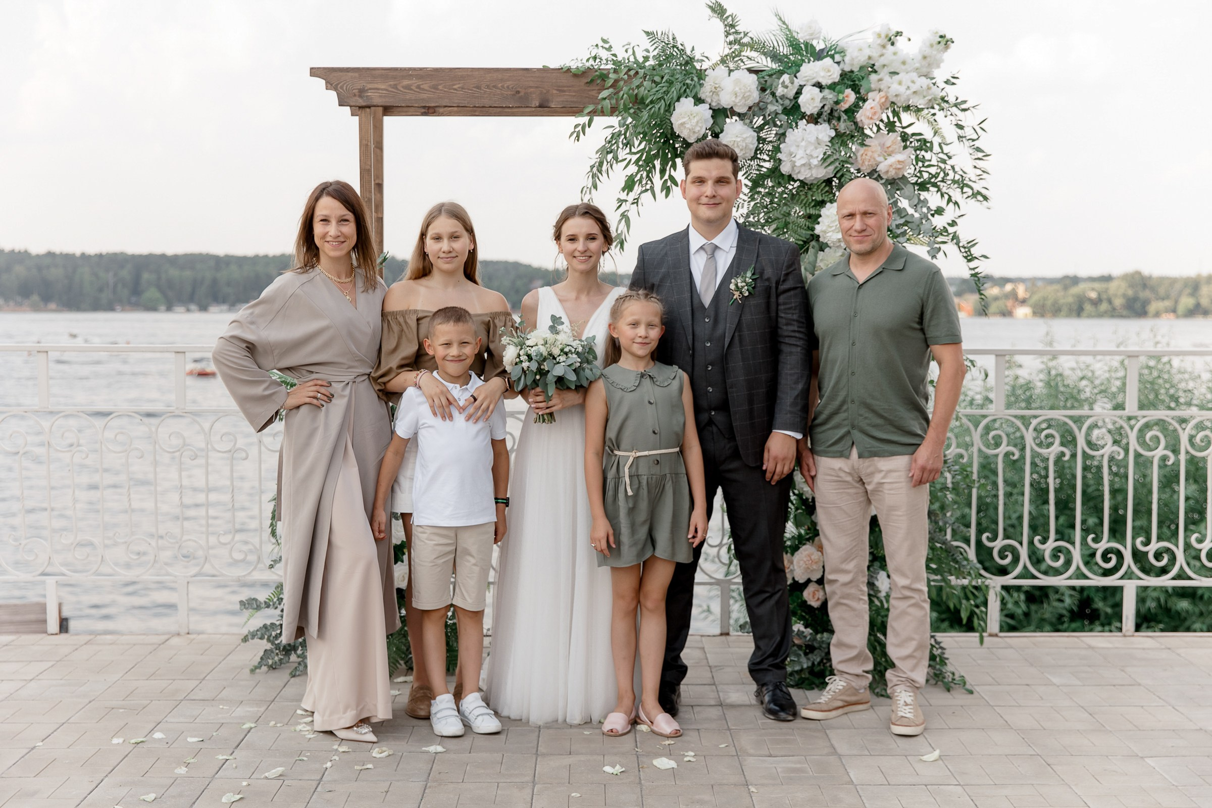 Family portrait after ceremony, by Bude, Cornwall reportage photographer.