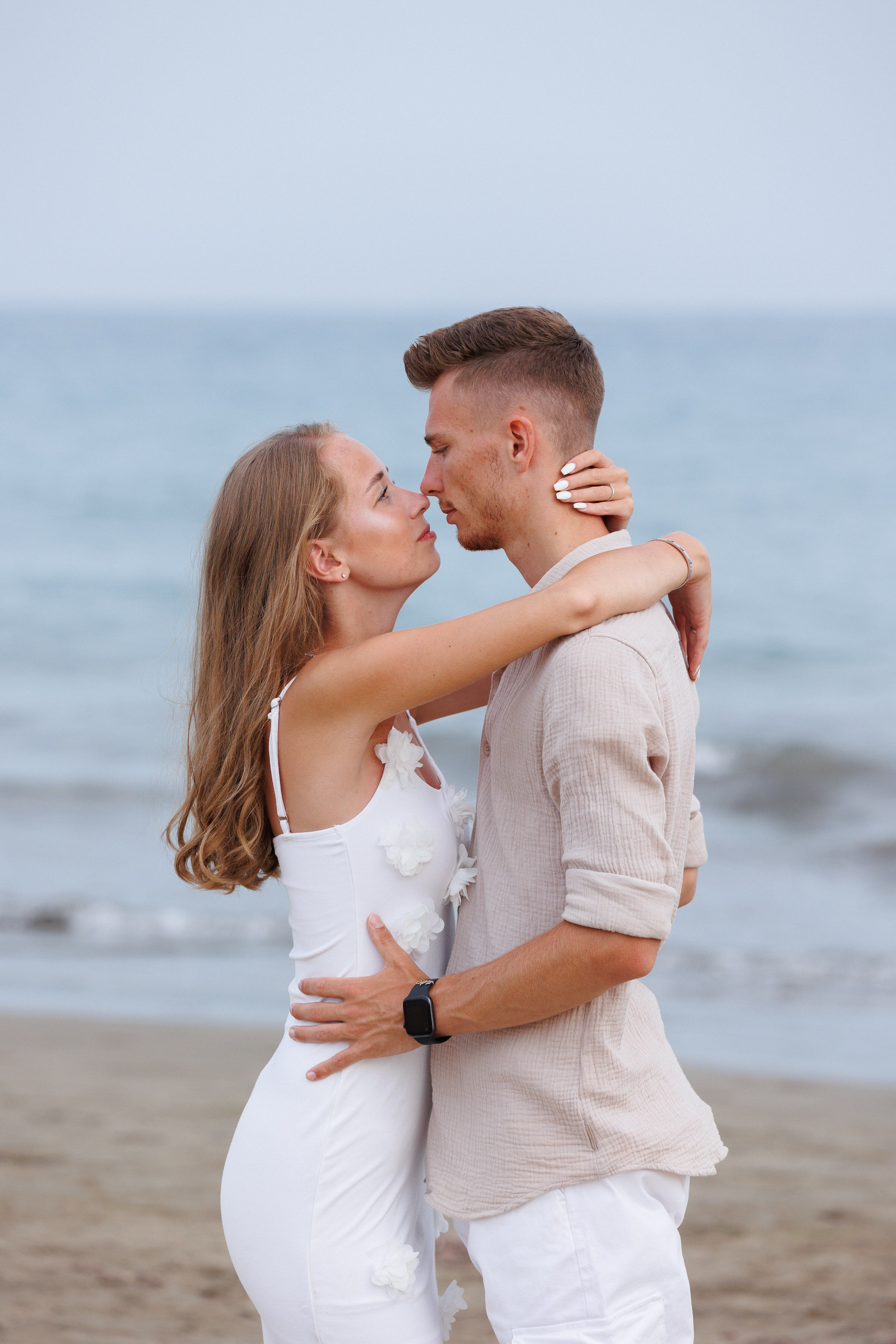 Couple embrace on Maspalomas beach vacation by Slavik Robtsenkov