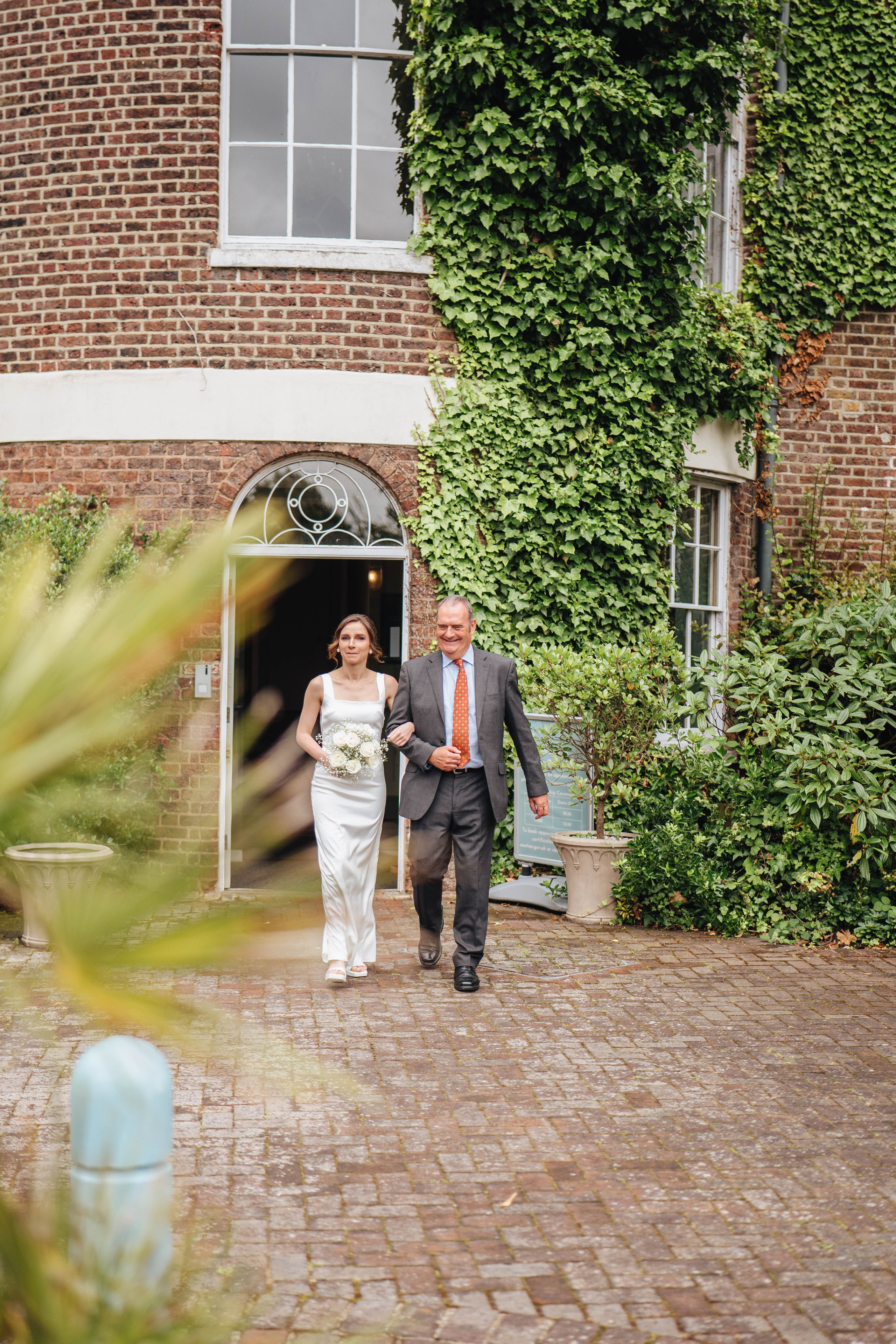 bride walking through the venue with her father