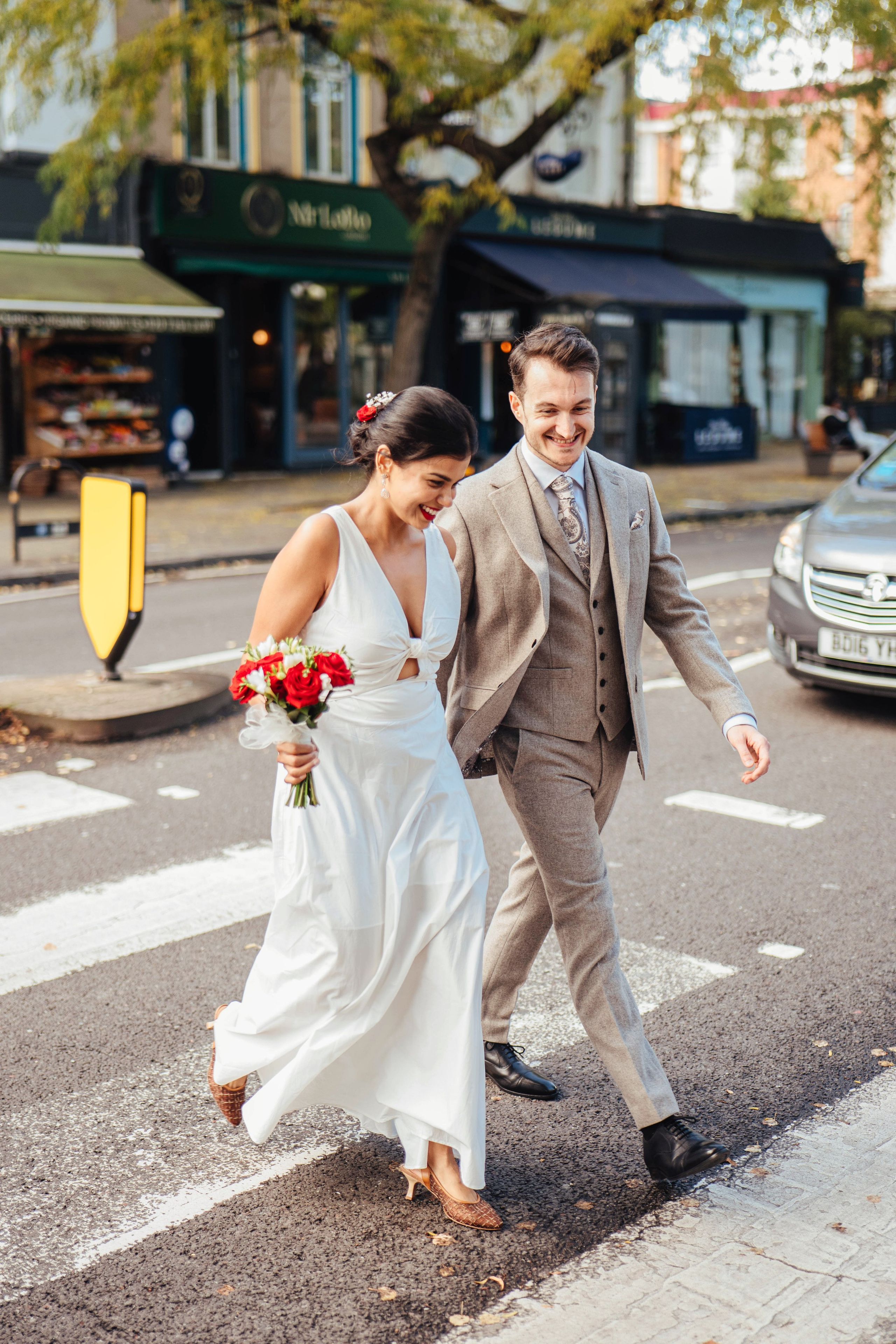 Wedding couple on the road crossing in Islington near Islington town hall