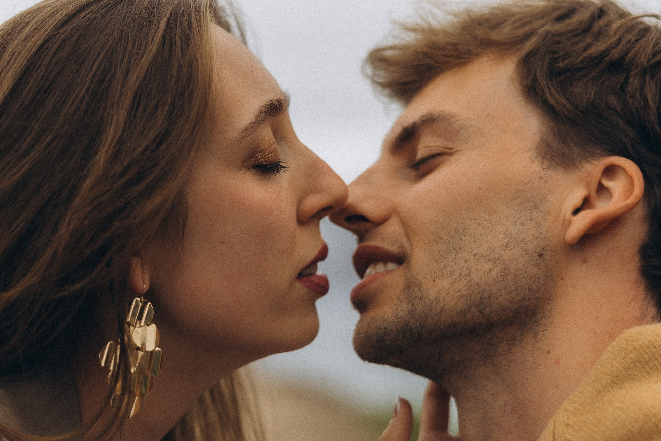 Romantic surprise proposal at sunset on a scenic cliffside in Madeira, Portugal, capturing the emotional moment of love and commitment.