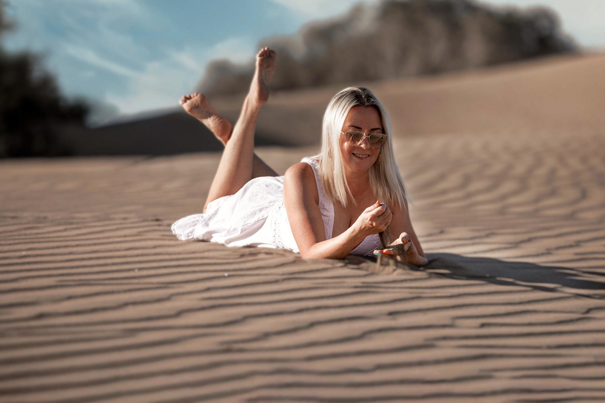 Desert Maspalomas Gran Canaria Photographer A woman laying on a sand dune.