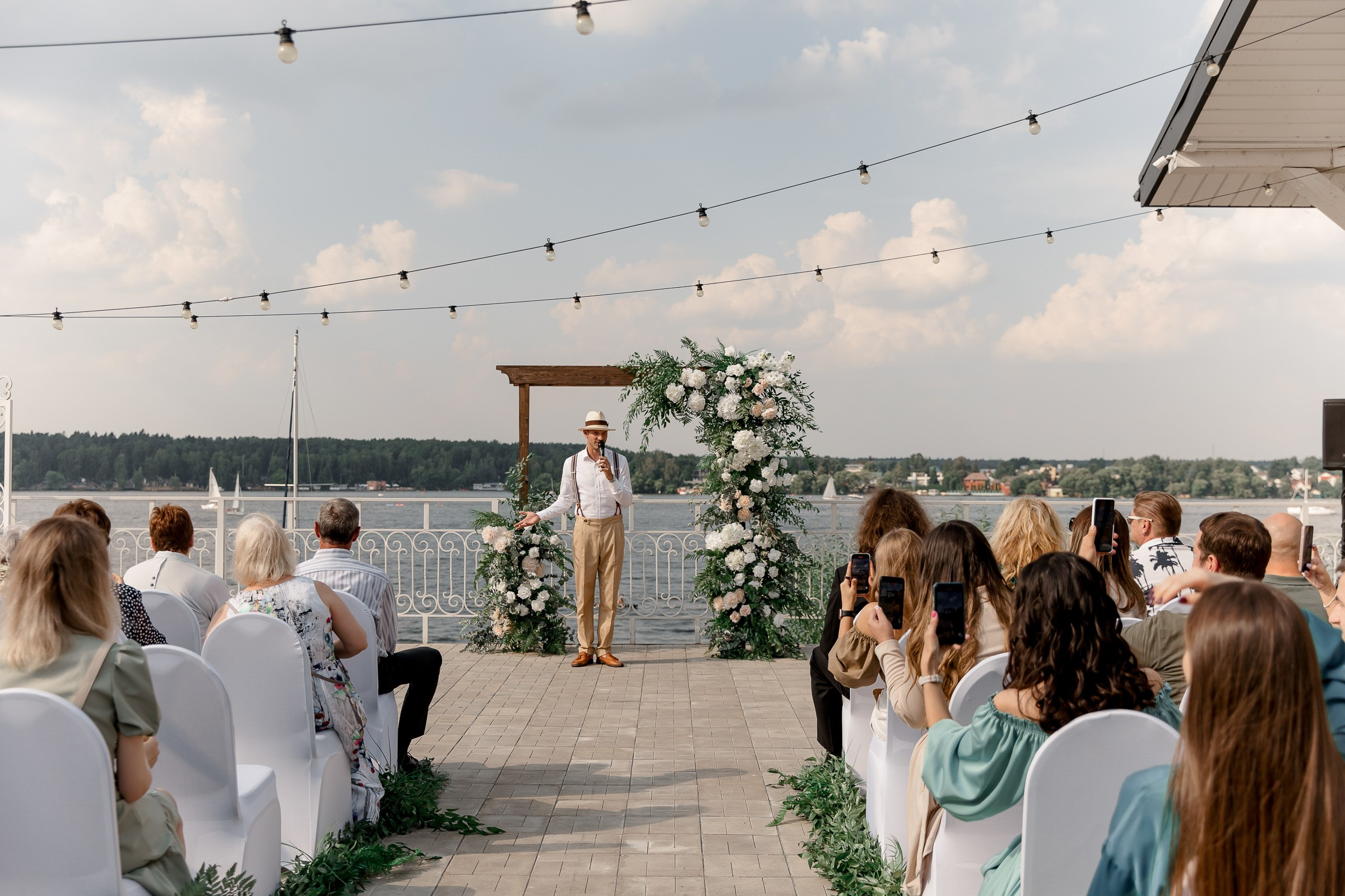 Wedding announcer talking to guests, by Bude, Cornwall editorial photographer
