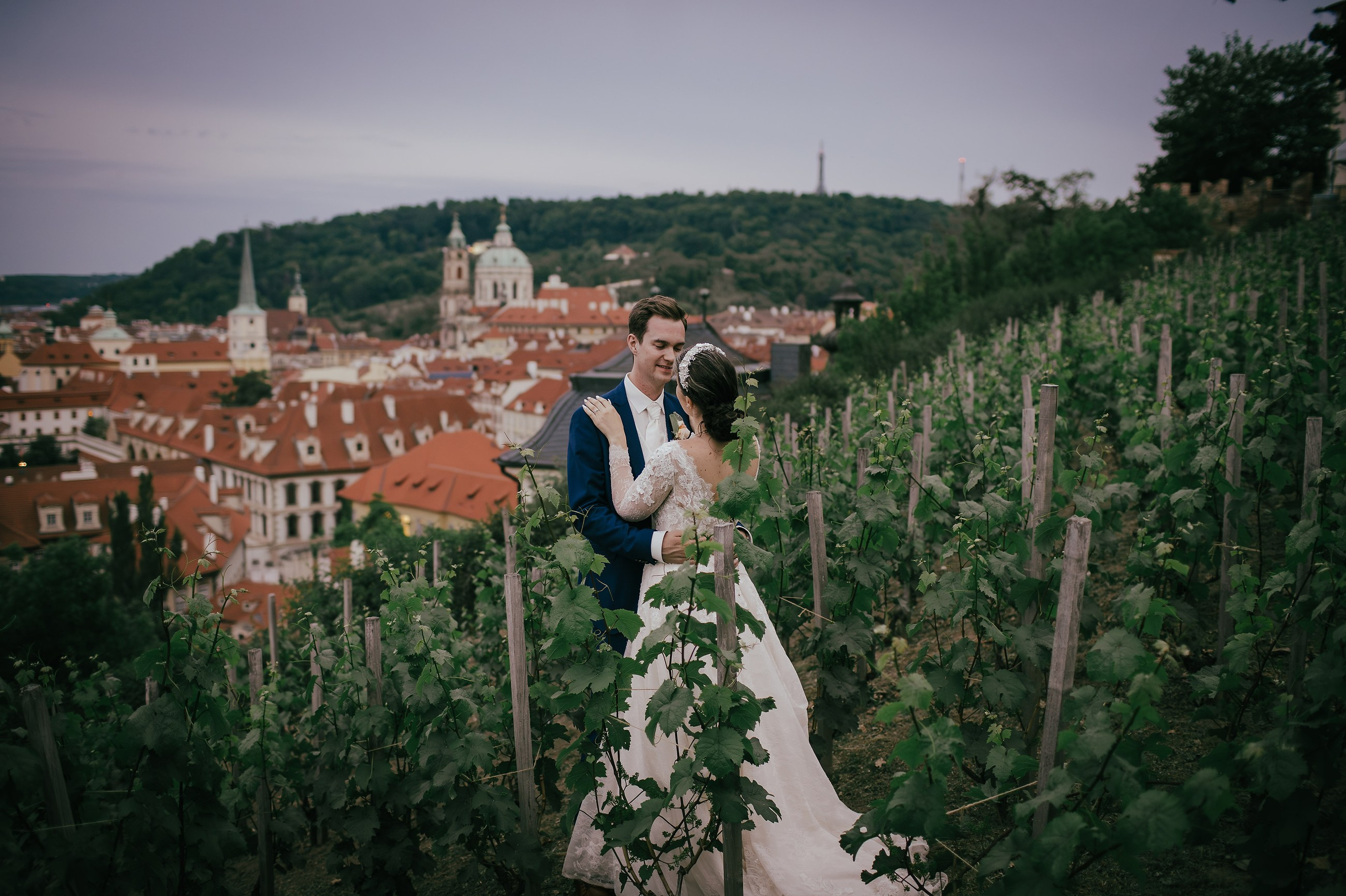 Surrounded by vineyards, newlyweds watch the sites and sounds of the historic city center of Prague below them from their vantage point at the Villa Richter.