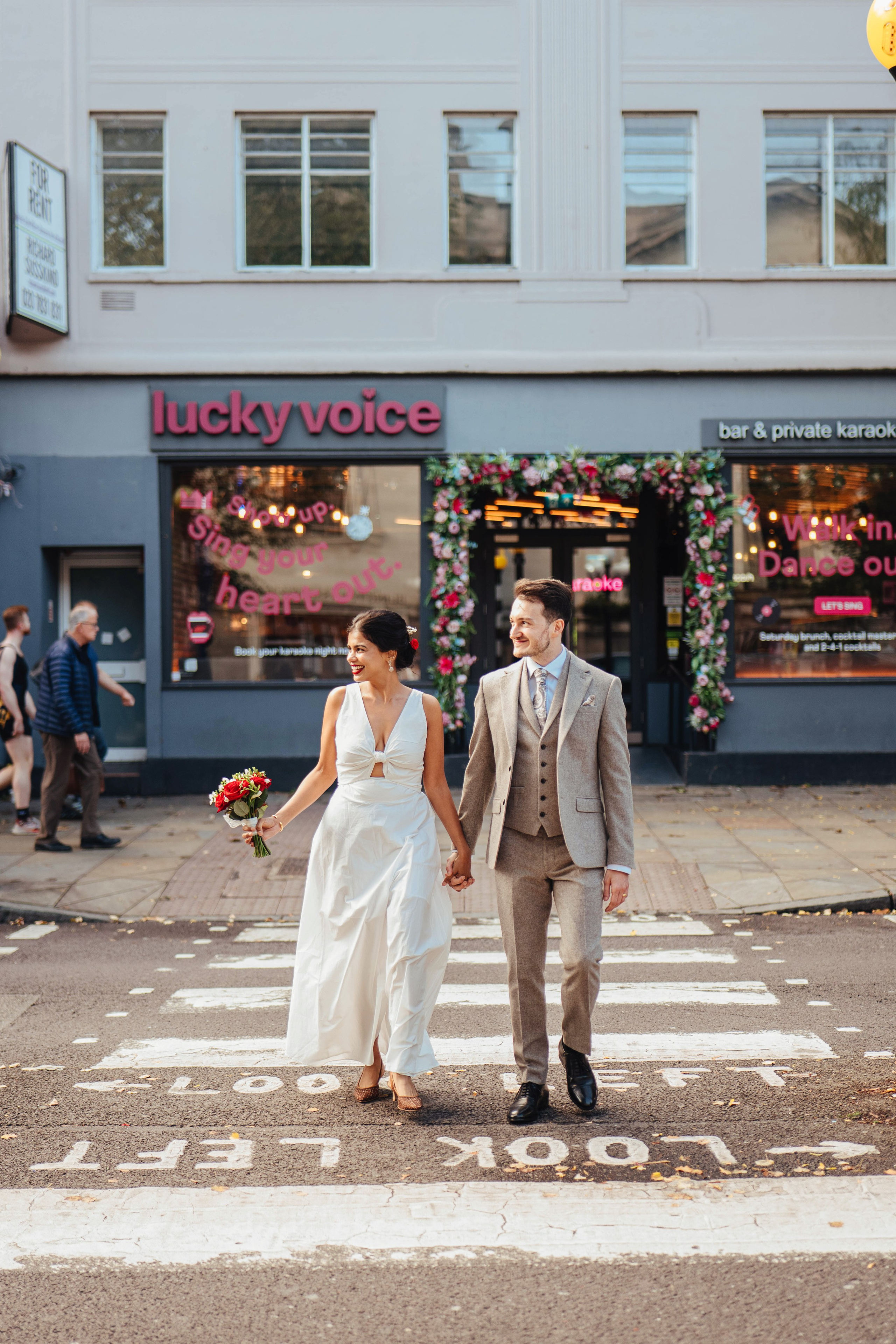 Wedding couple on the road crossing in Islington near Islington town hall
