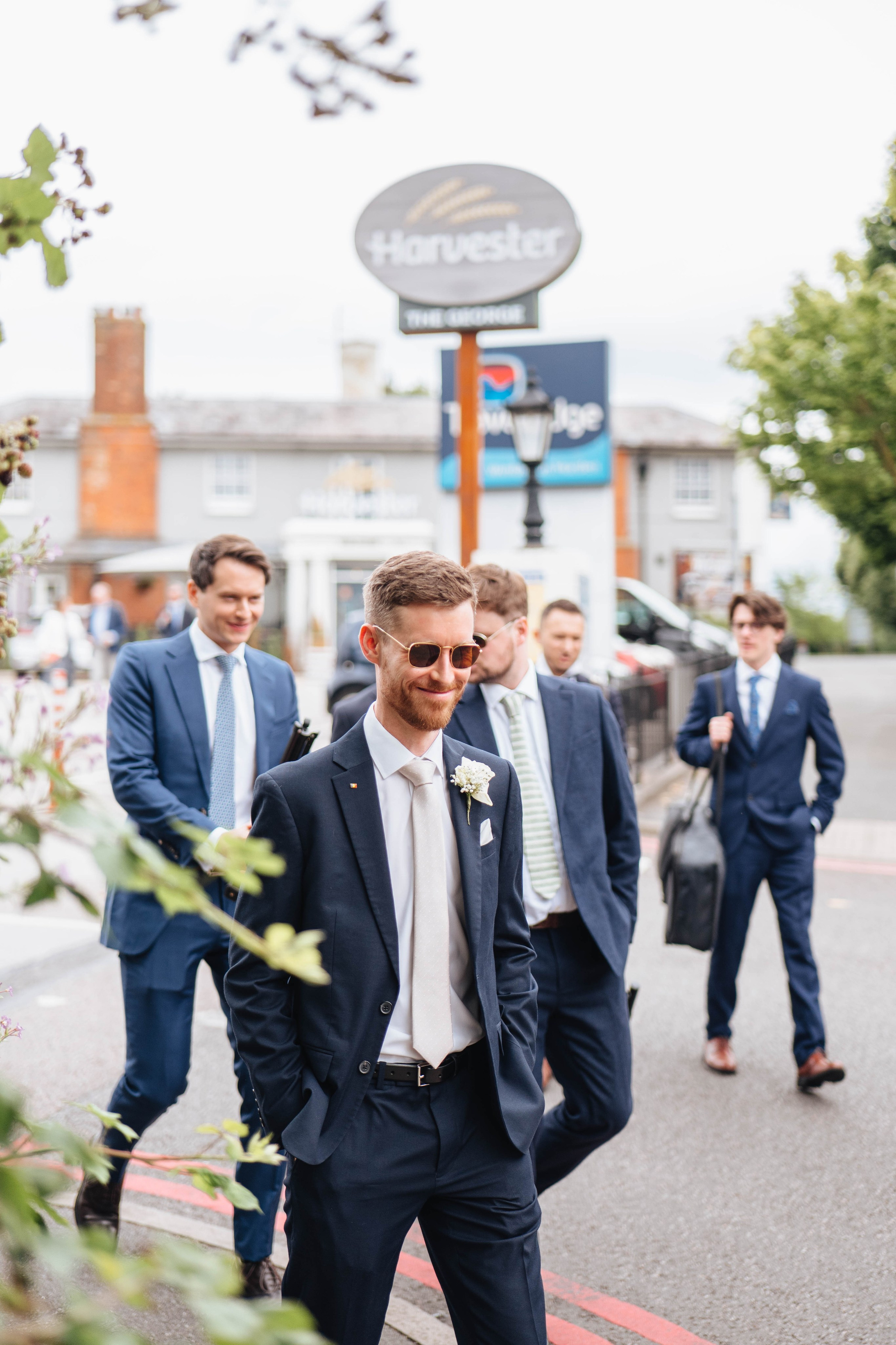 groom and his friends walking to the wedding site