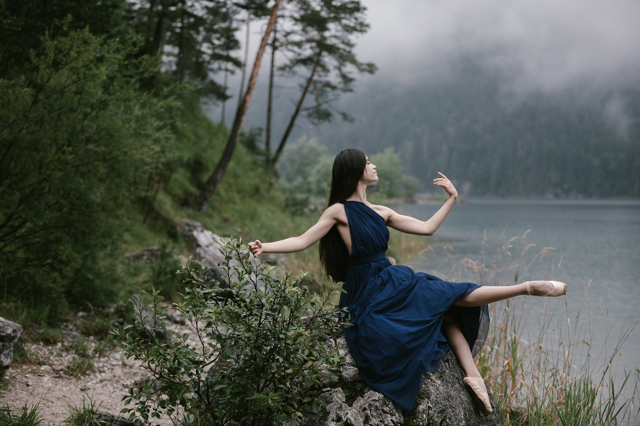Ballet dancer on rock by Eibsee mountain lake