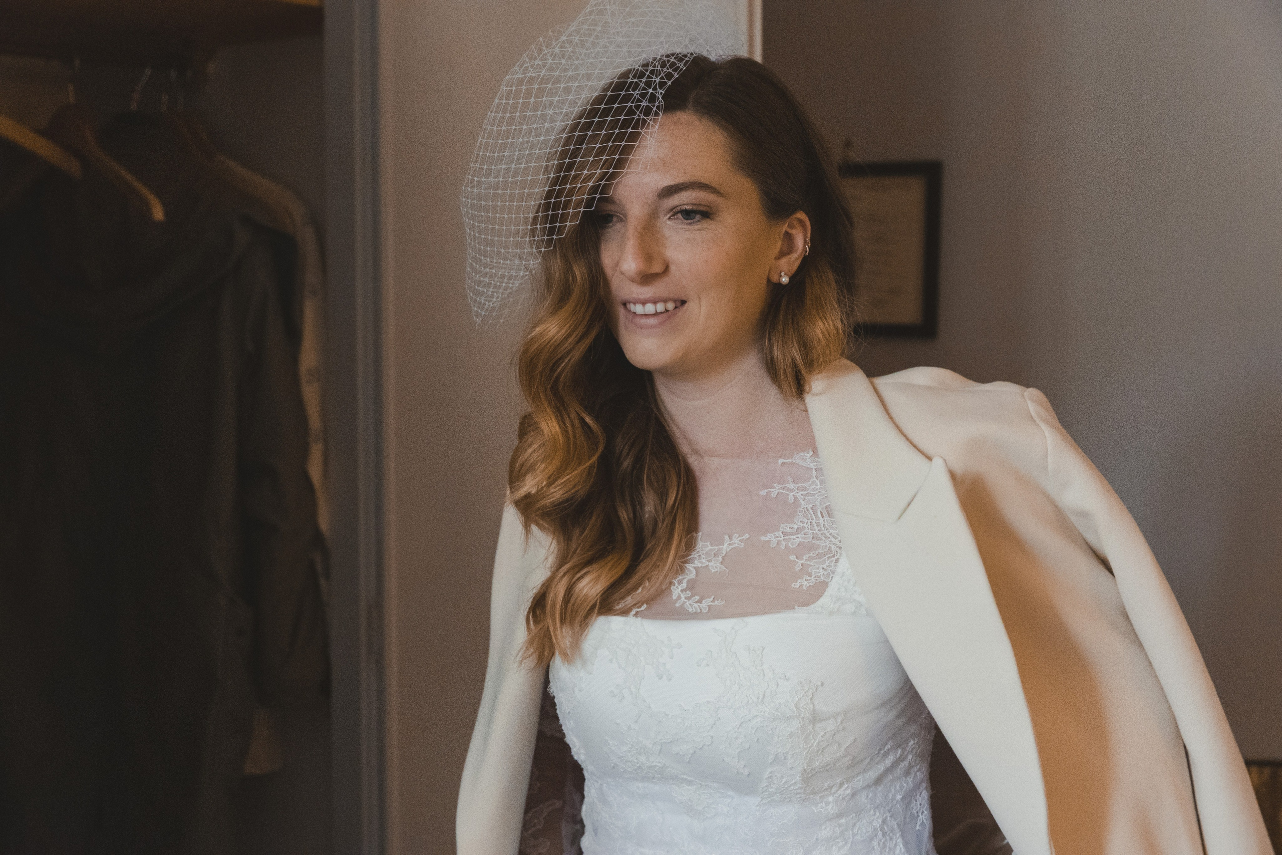 A woman getting ready at Hotel Lancelot, adjusting her wedding veil.