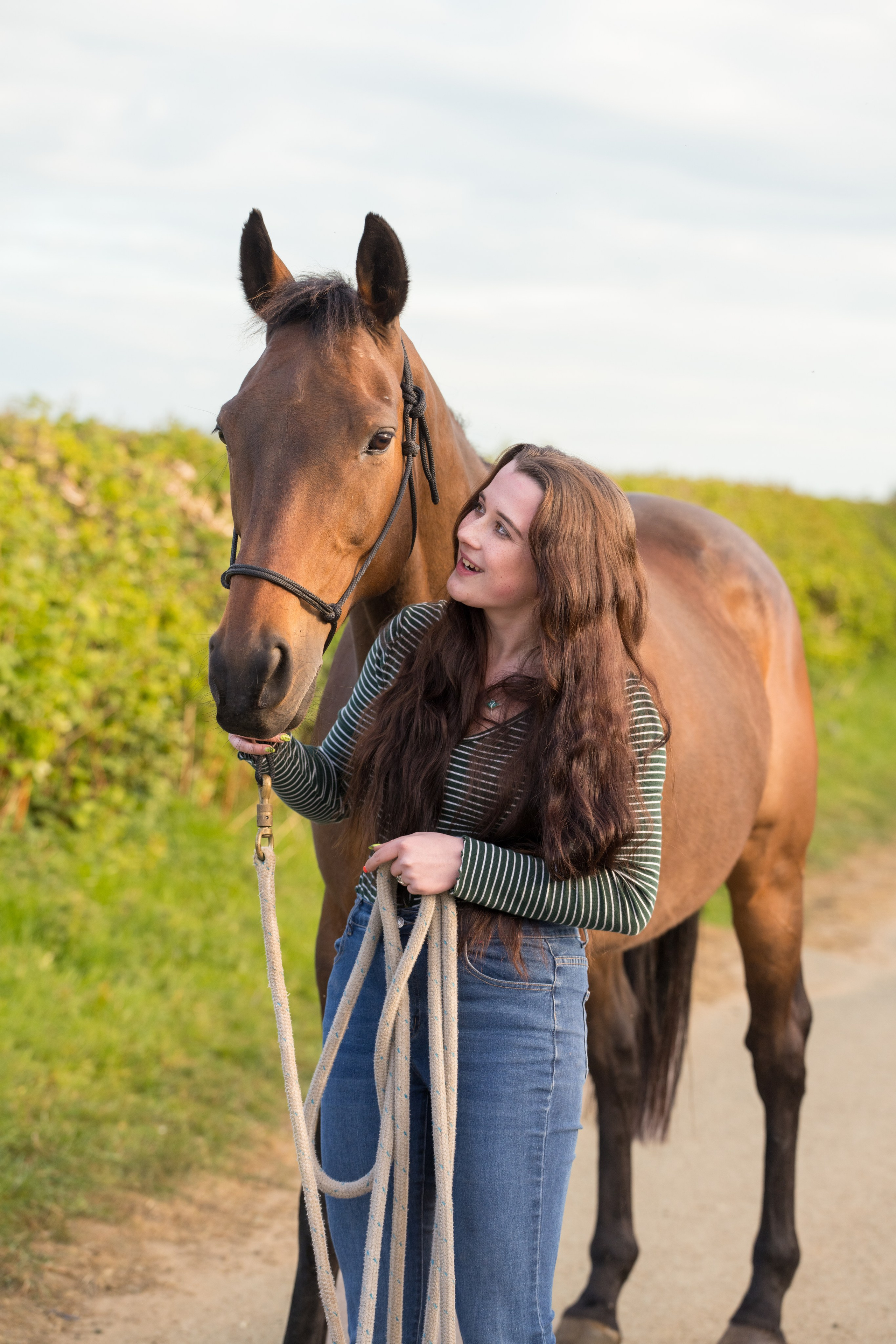 Horse and teen posing together during golden hour equine photoshoot in Leicestershire