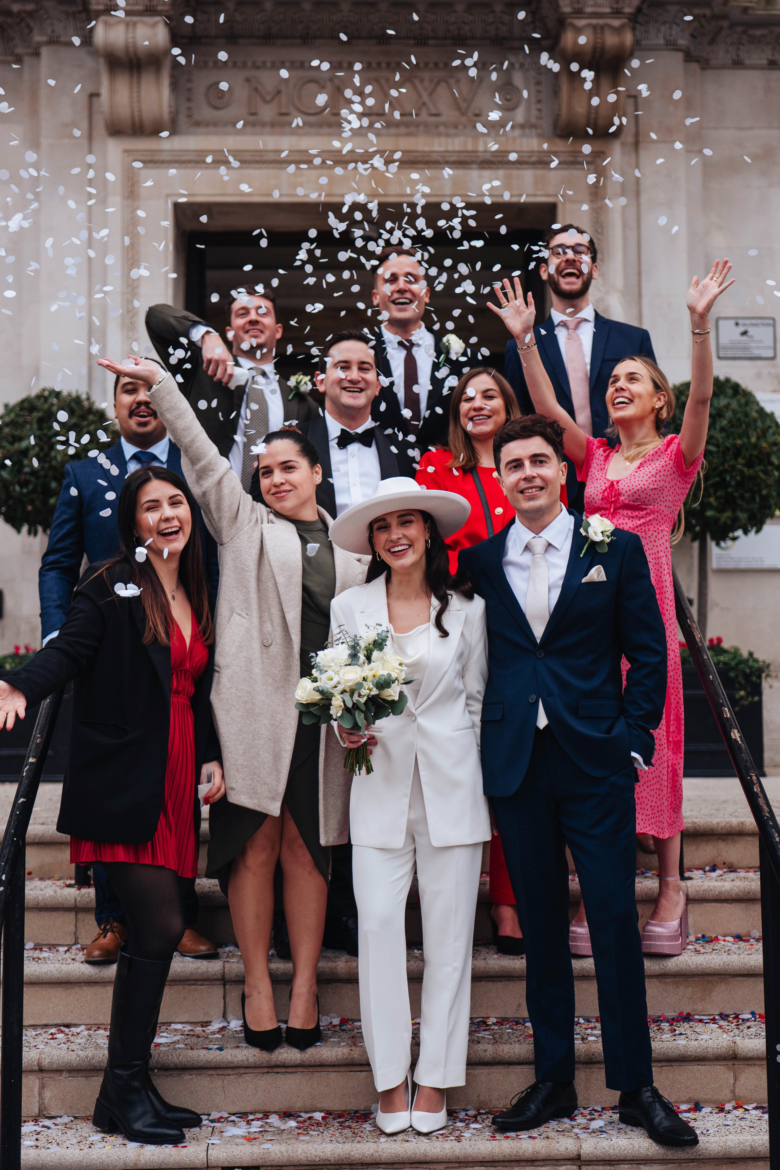 Exit from Islington town hall, meeting the couple with confetti, group photo