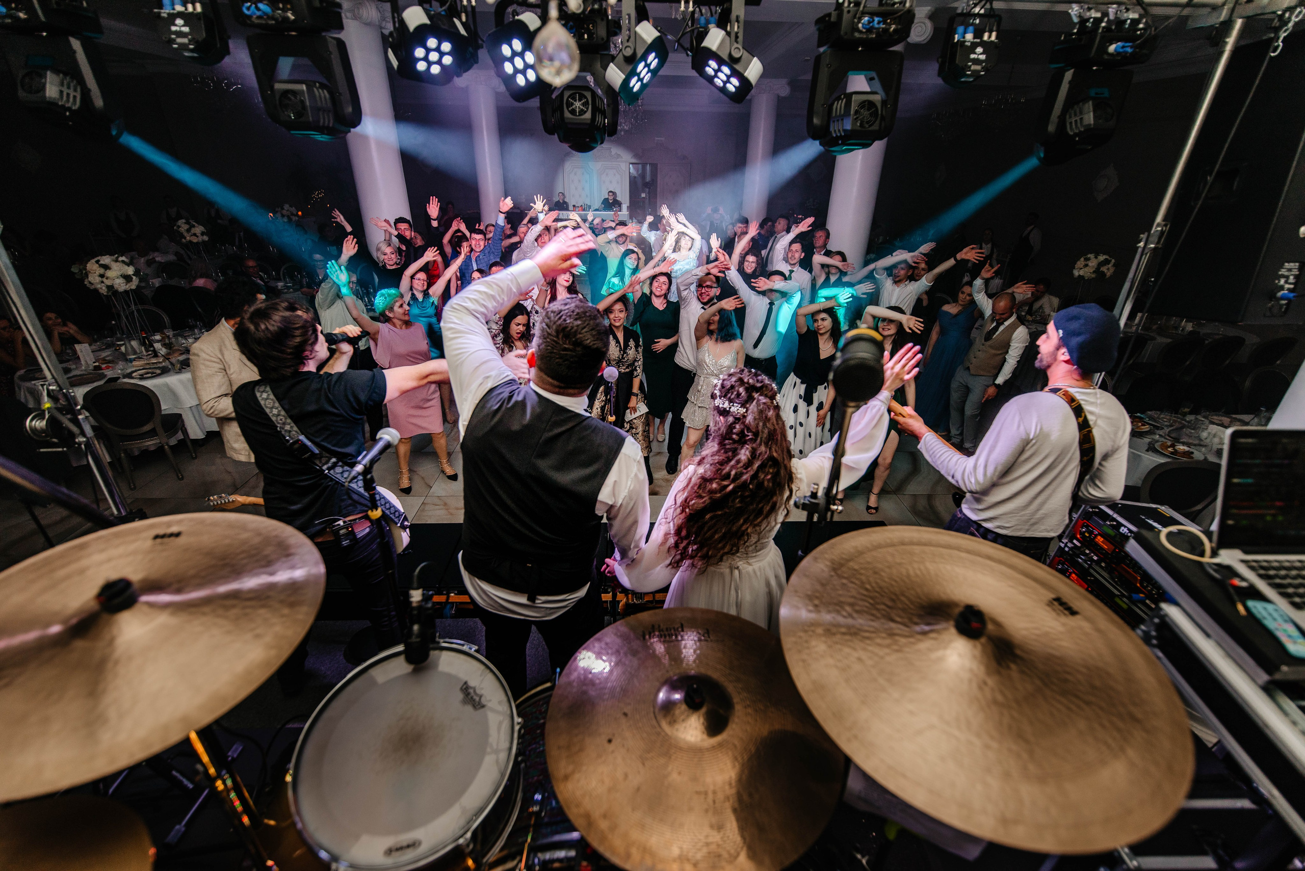 Radu Rahovan Fotograf de nuntă Cluj – mirii pe scenă, alături de formație, invitații dansând în ritmul lor.