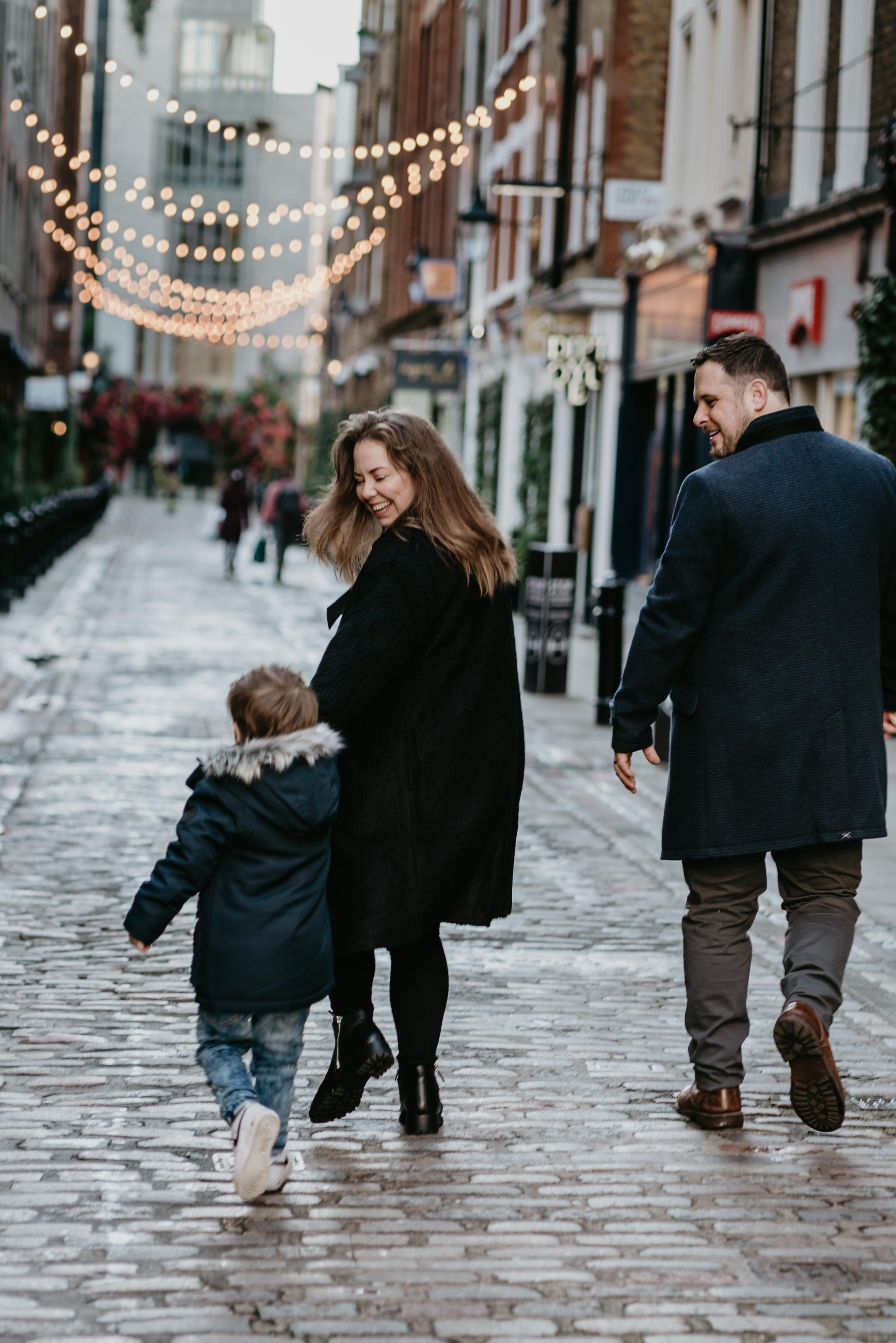 family walking on narrow street 