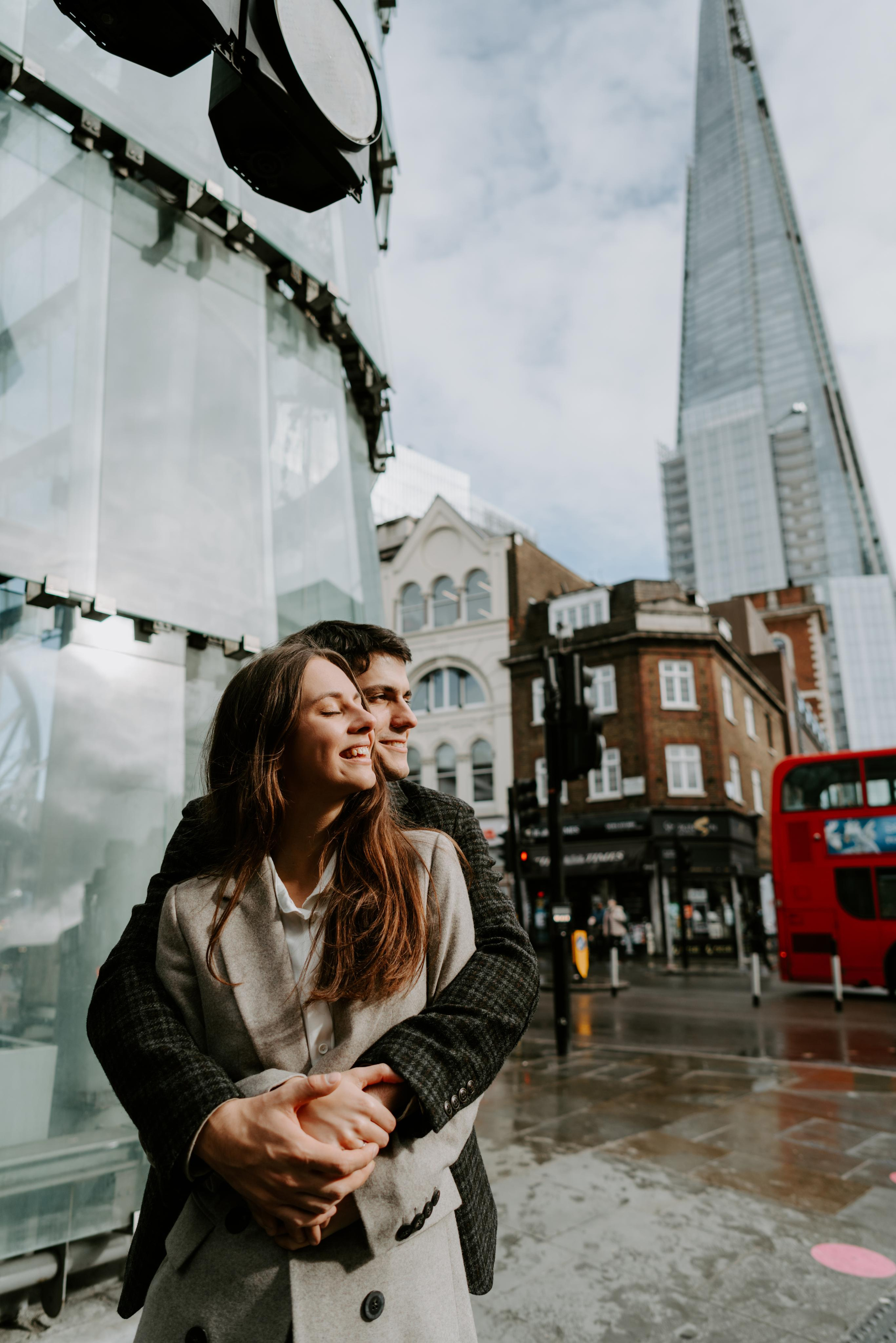 young couple hugging with shard on the background 