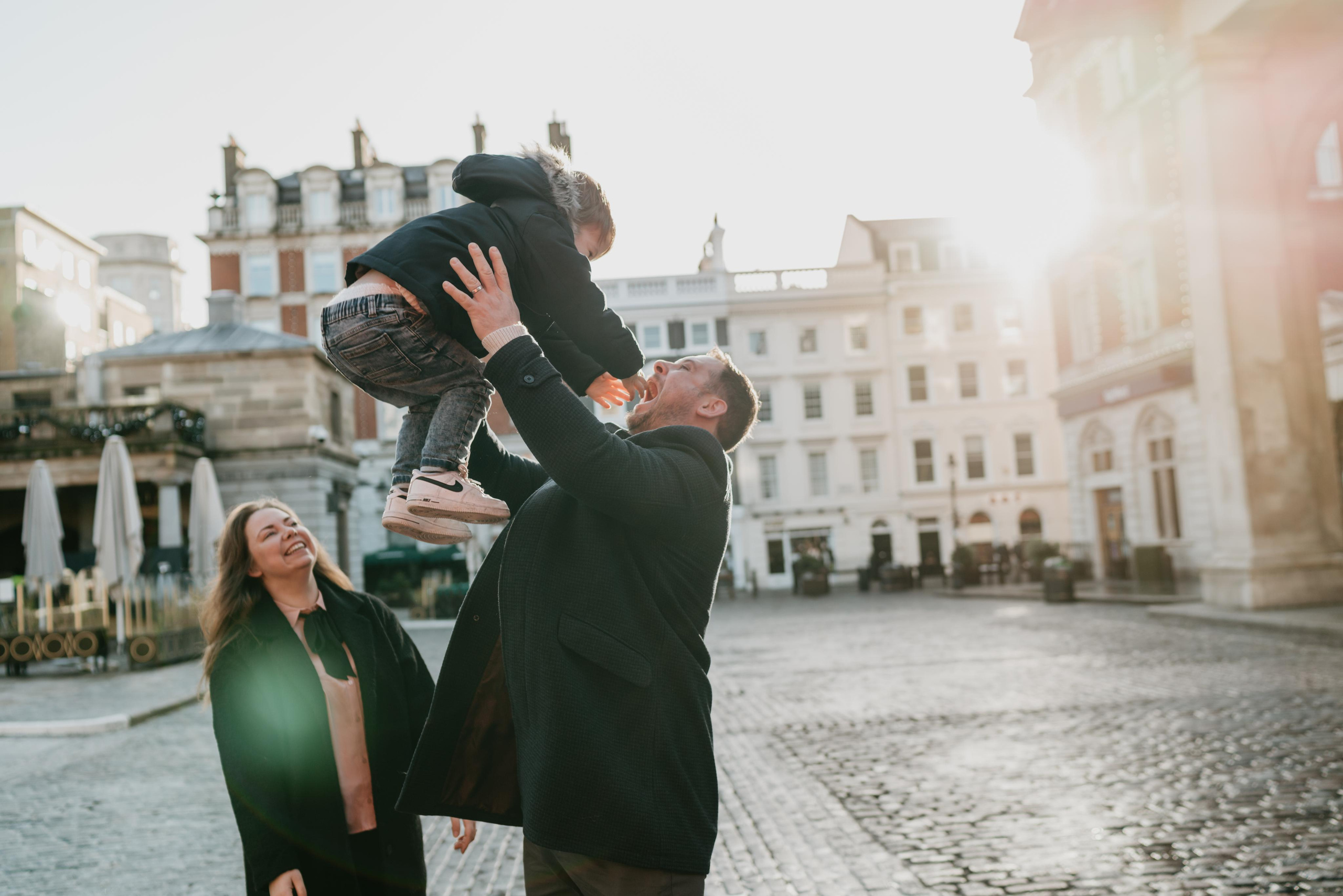 young parents playing with kid