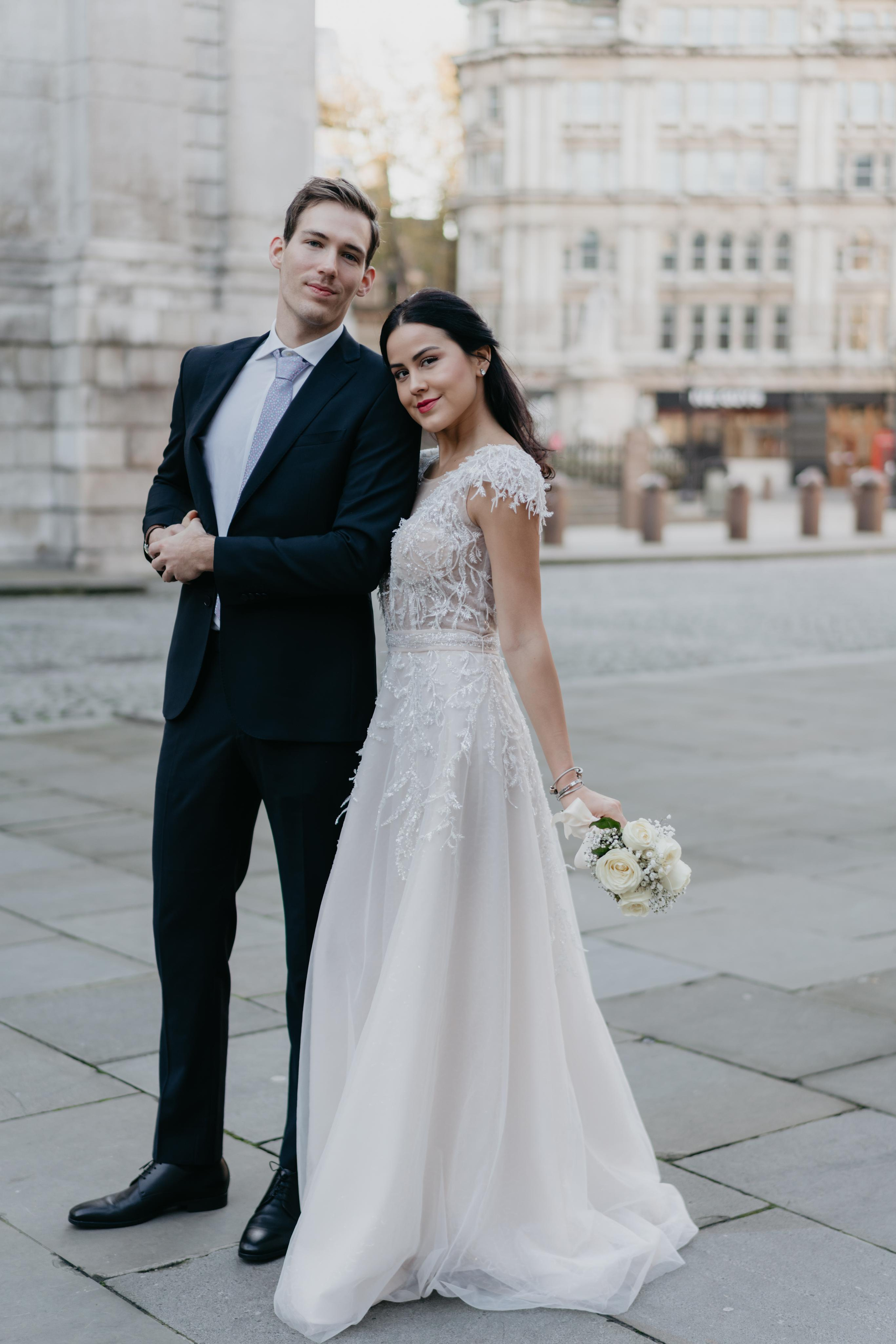 young couple posing in wedding gown