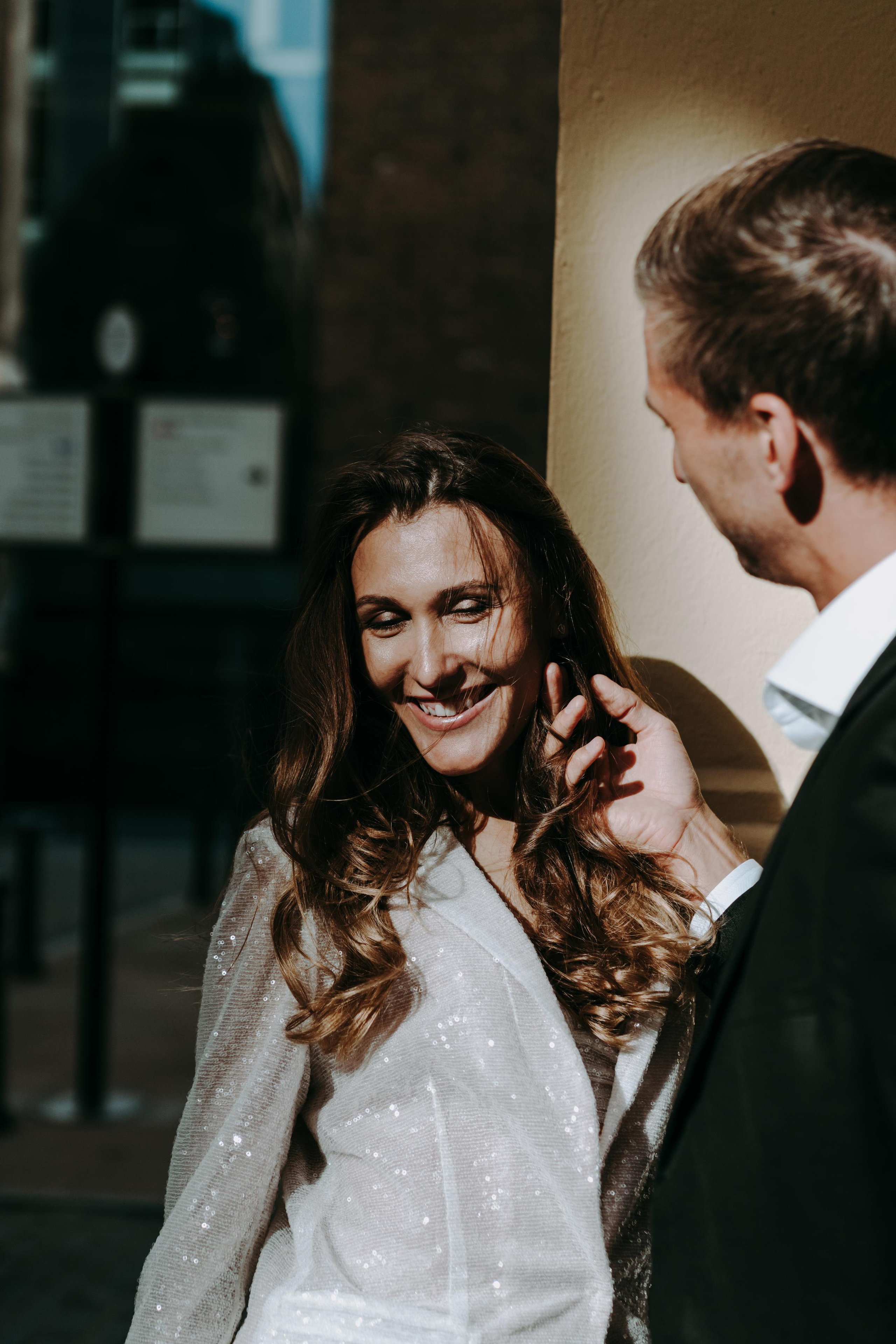 young man touching women hear 