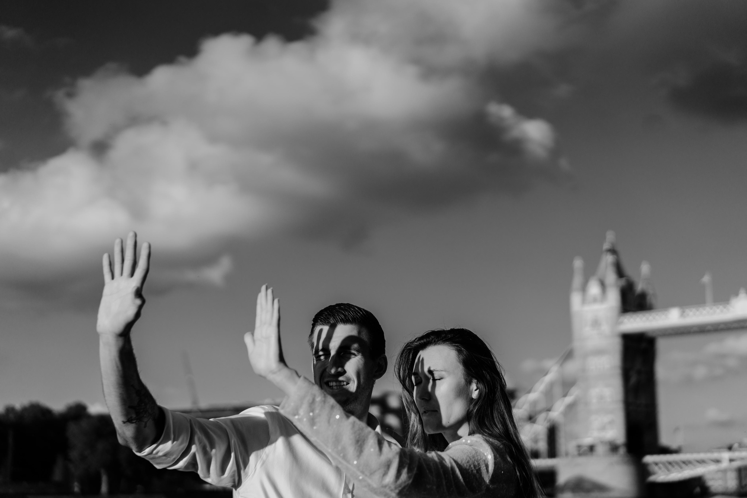 young couple covering faces from sun lights 