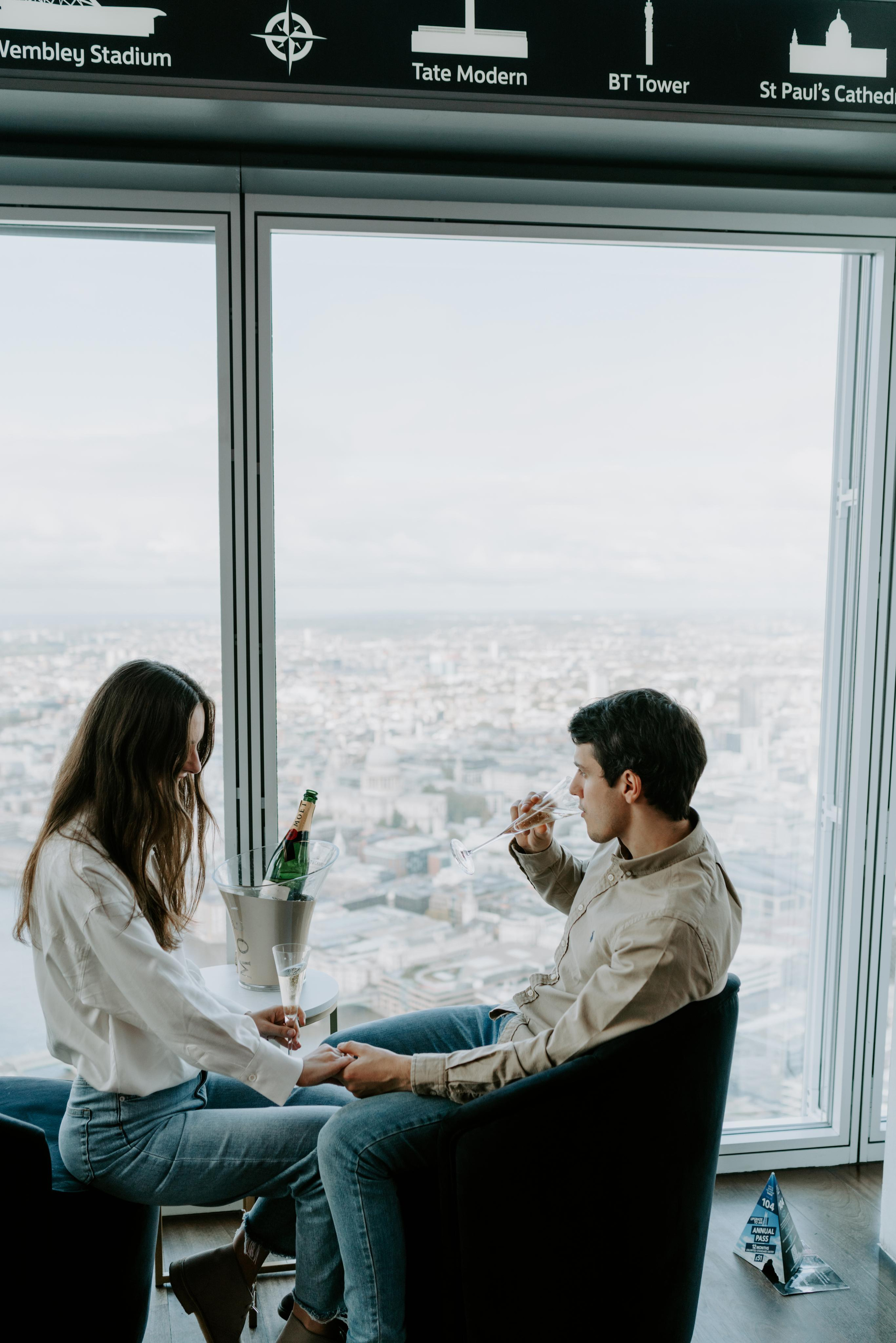 young couple drinking Champagne with city view