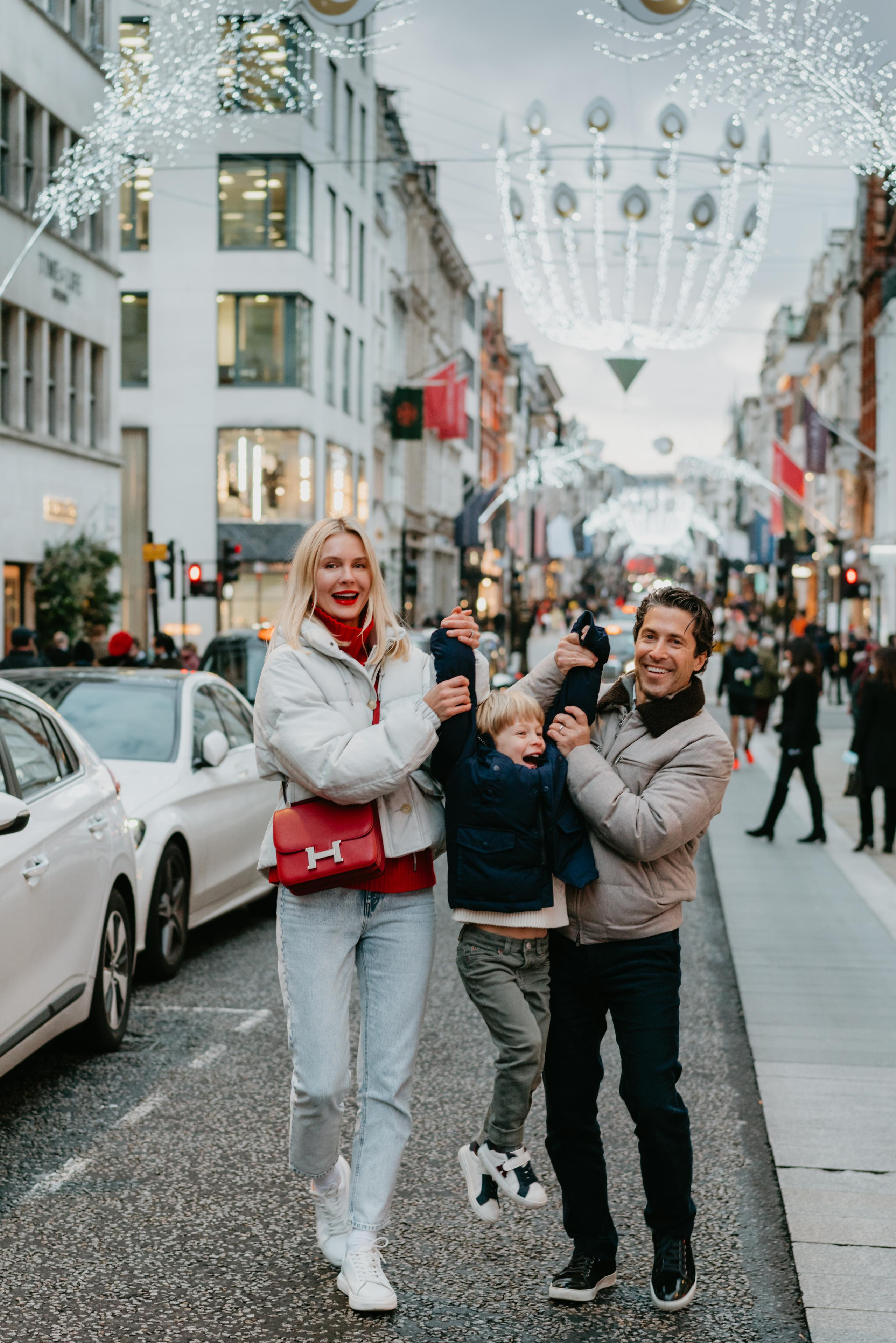 happy kids jumping with parents on the street 