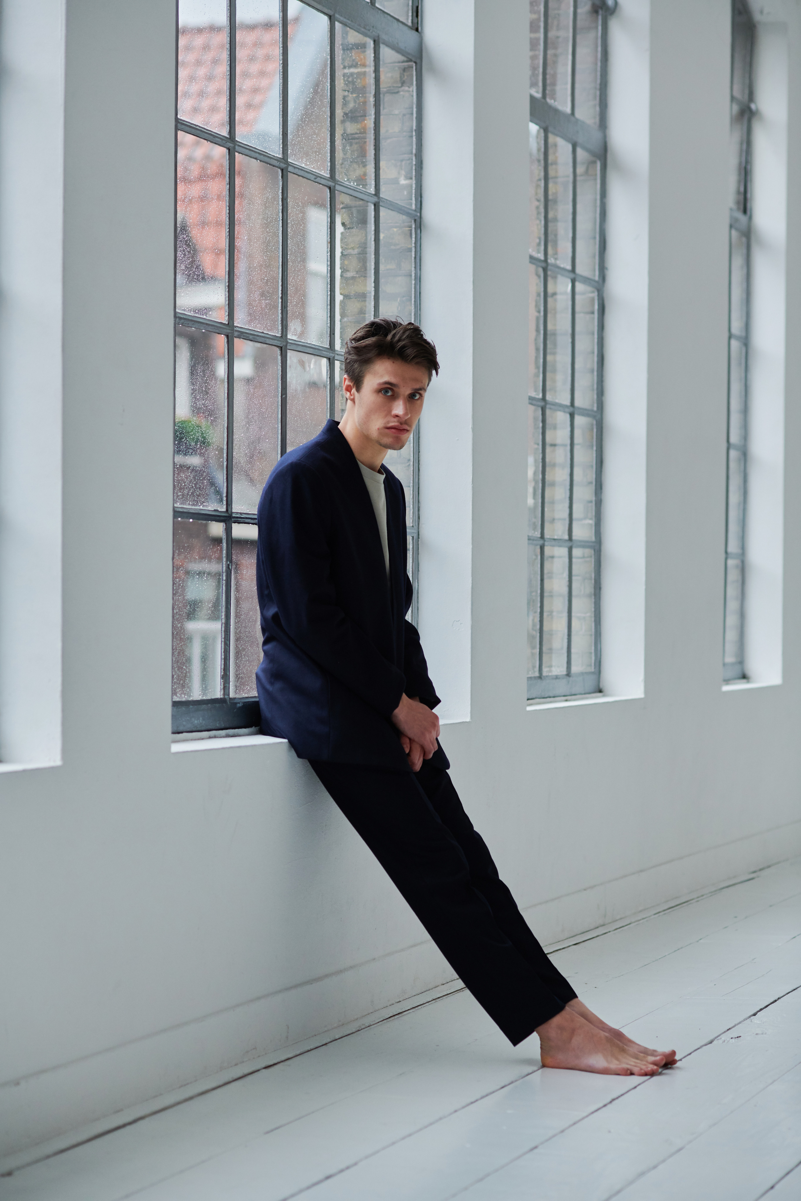 Portrait of Gijs Blom, in front of the window in the  Amsterdam photo studio