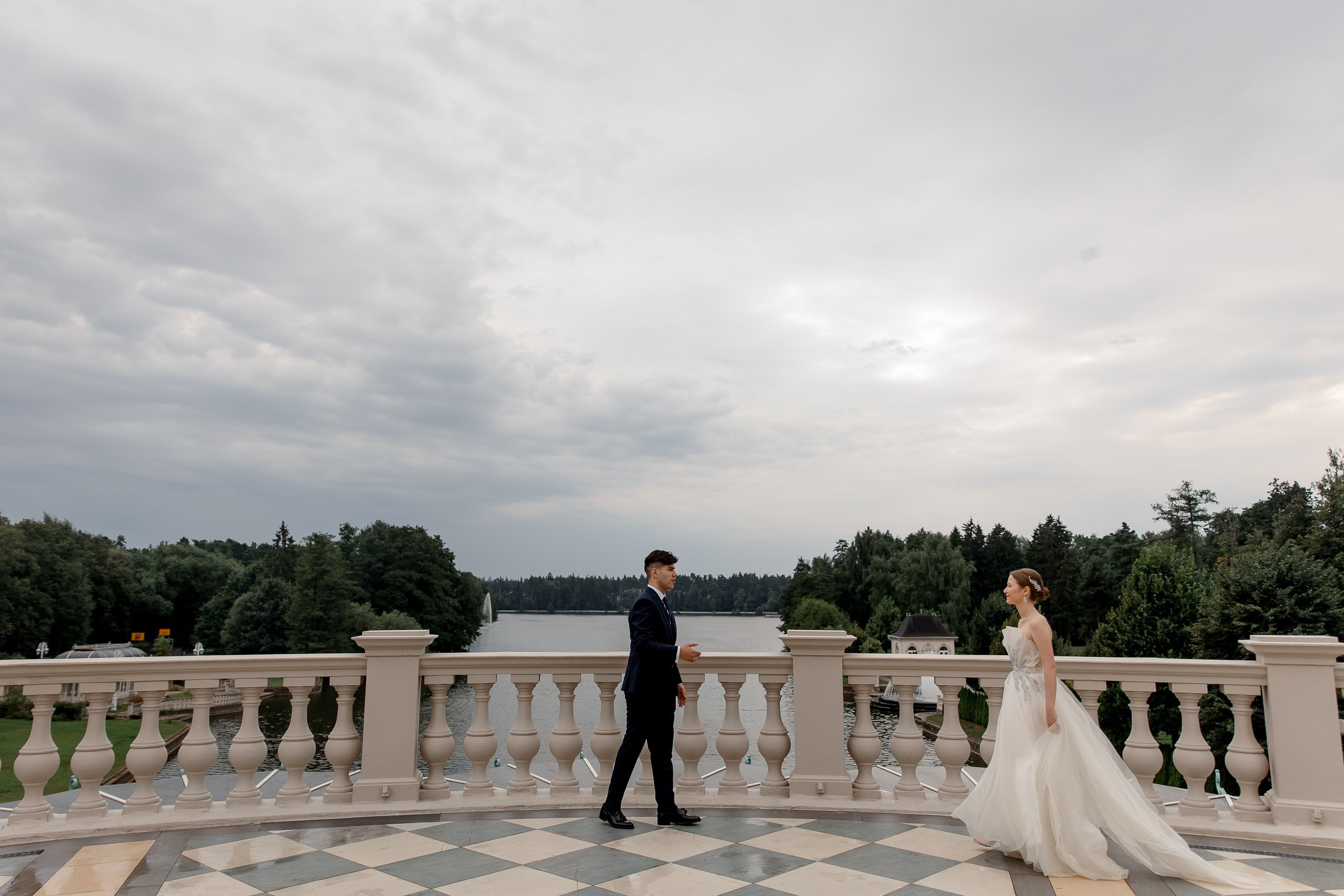Bride and groom meet at balcony, by Cornwall editorial photographer.