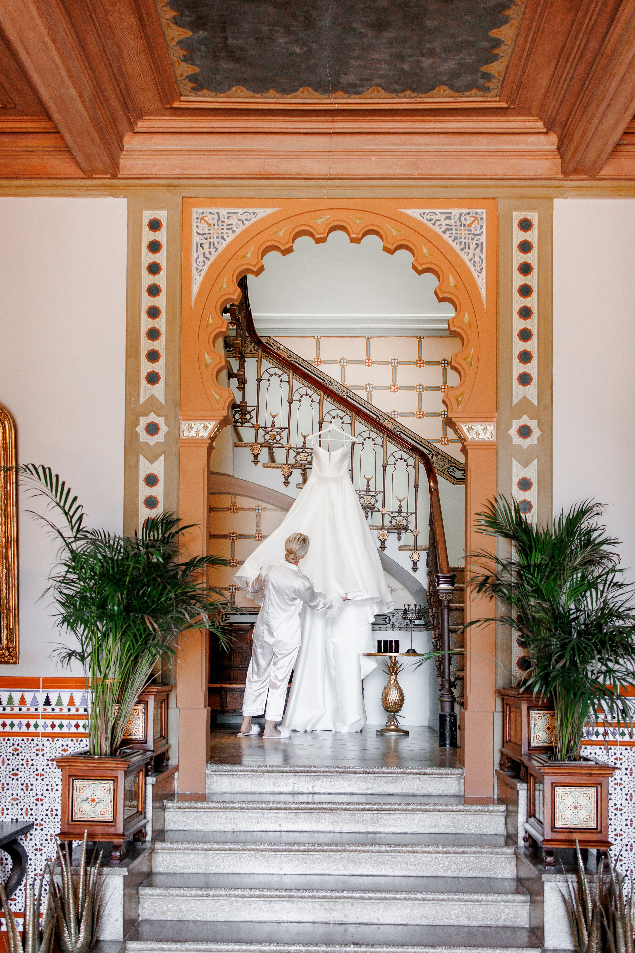 The bride enjoys her stylish wedding dress before putting it on