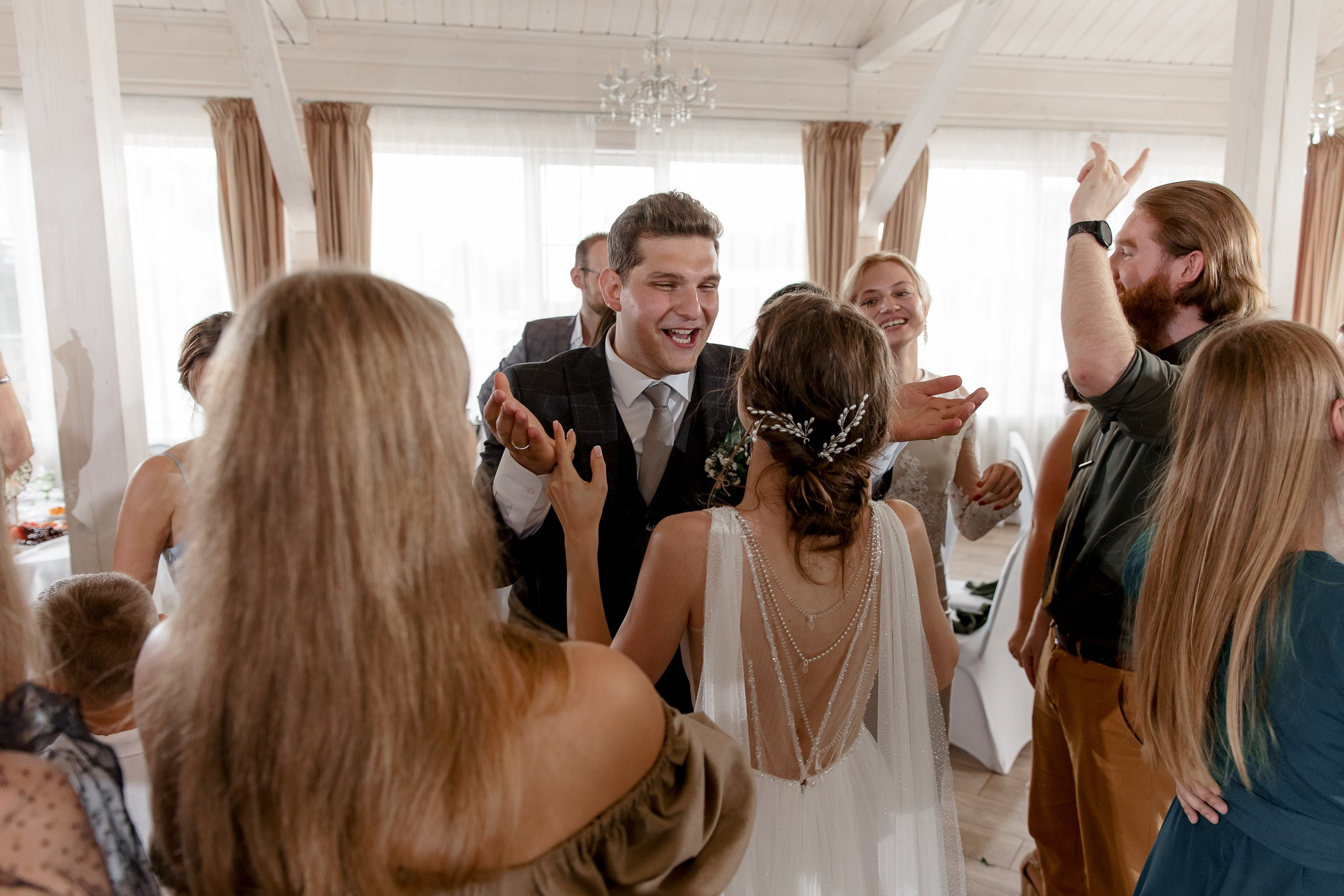 Guests celebrating reception, by Bude, Cornwall wedding photographer.