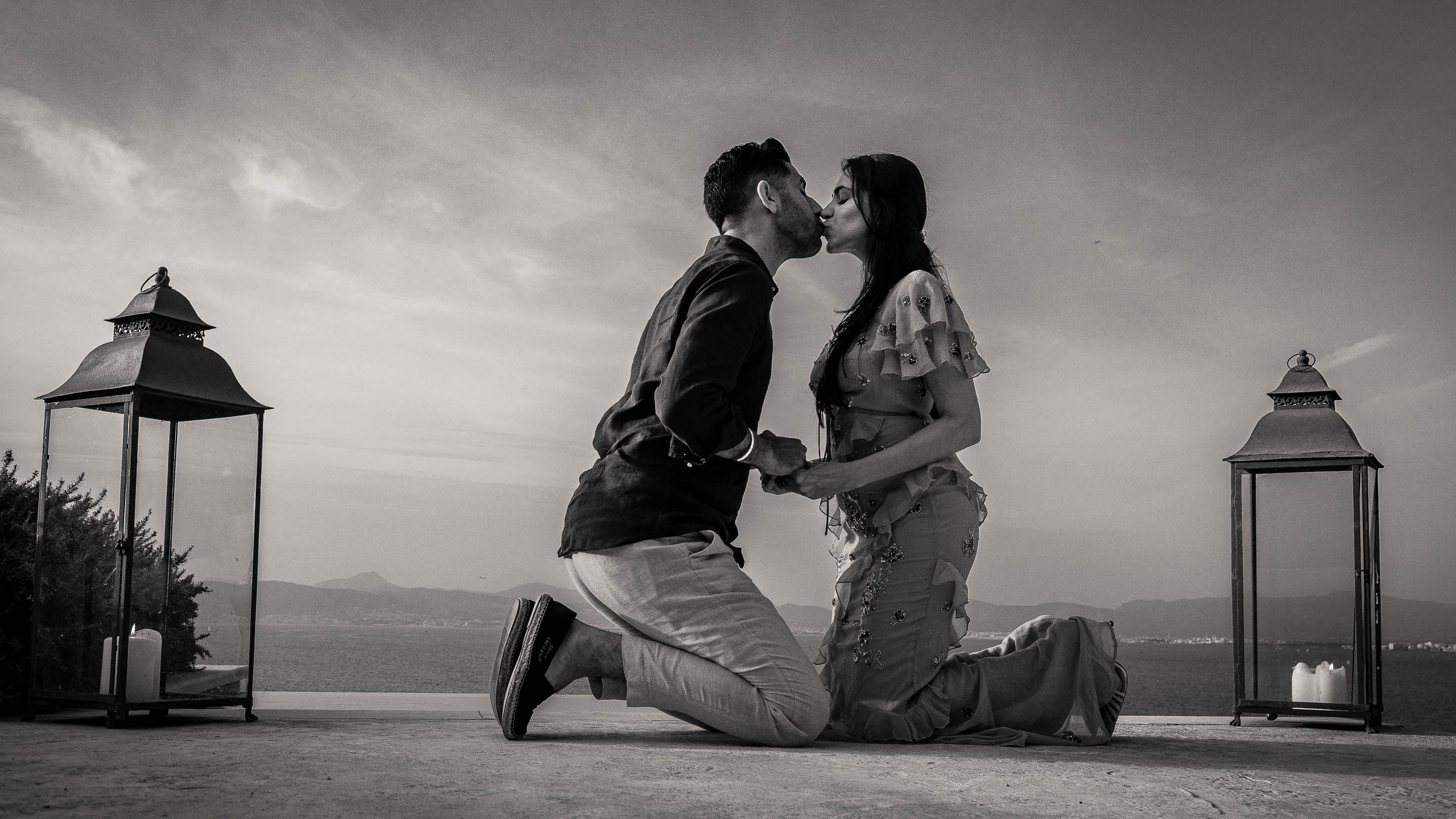 couple kneeling on the floor just after groom requests the bride to marry him in Mallorca