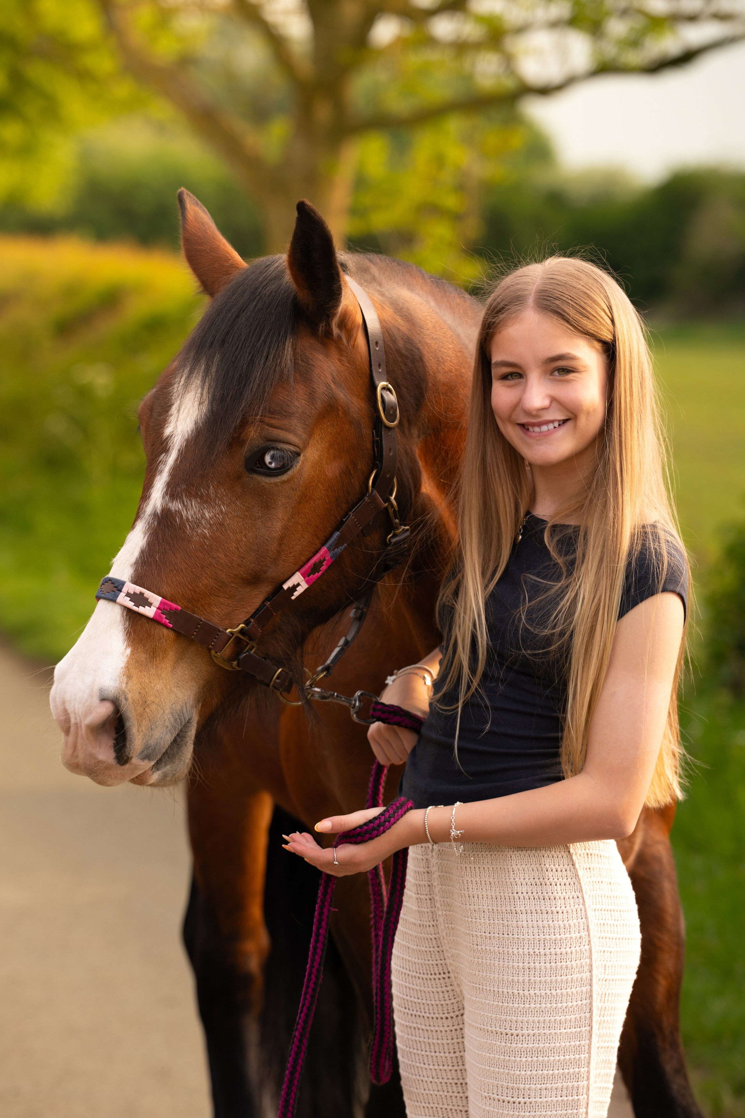 Horse and teen posing together during golden hour equine photoshoot in Leicestershire