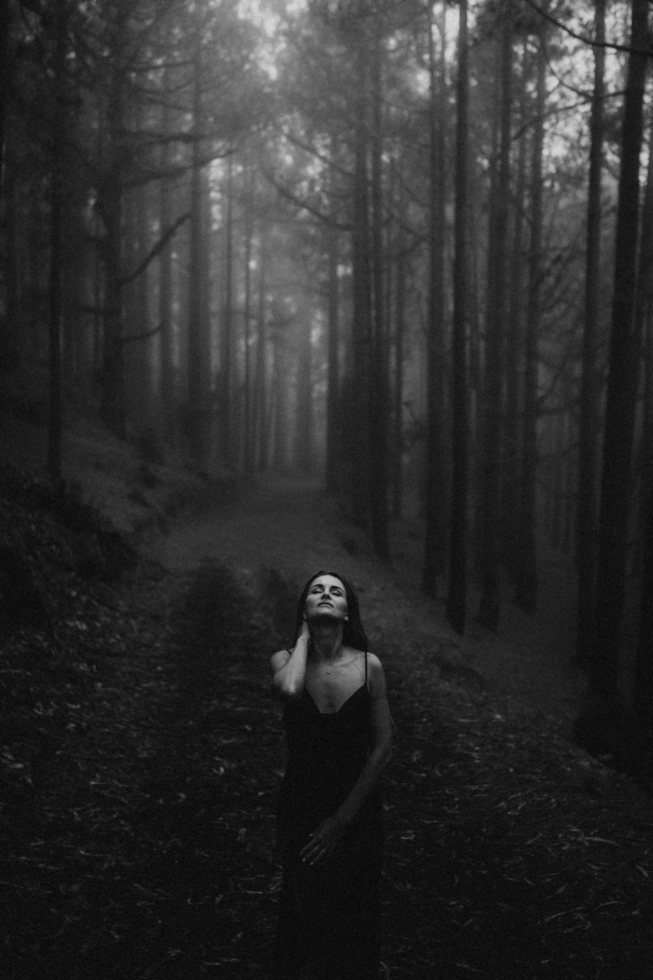Black and white photo lady in forest dramatic look