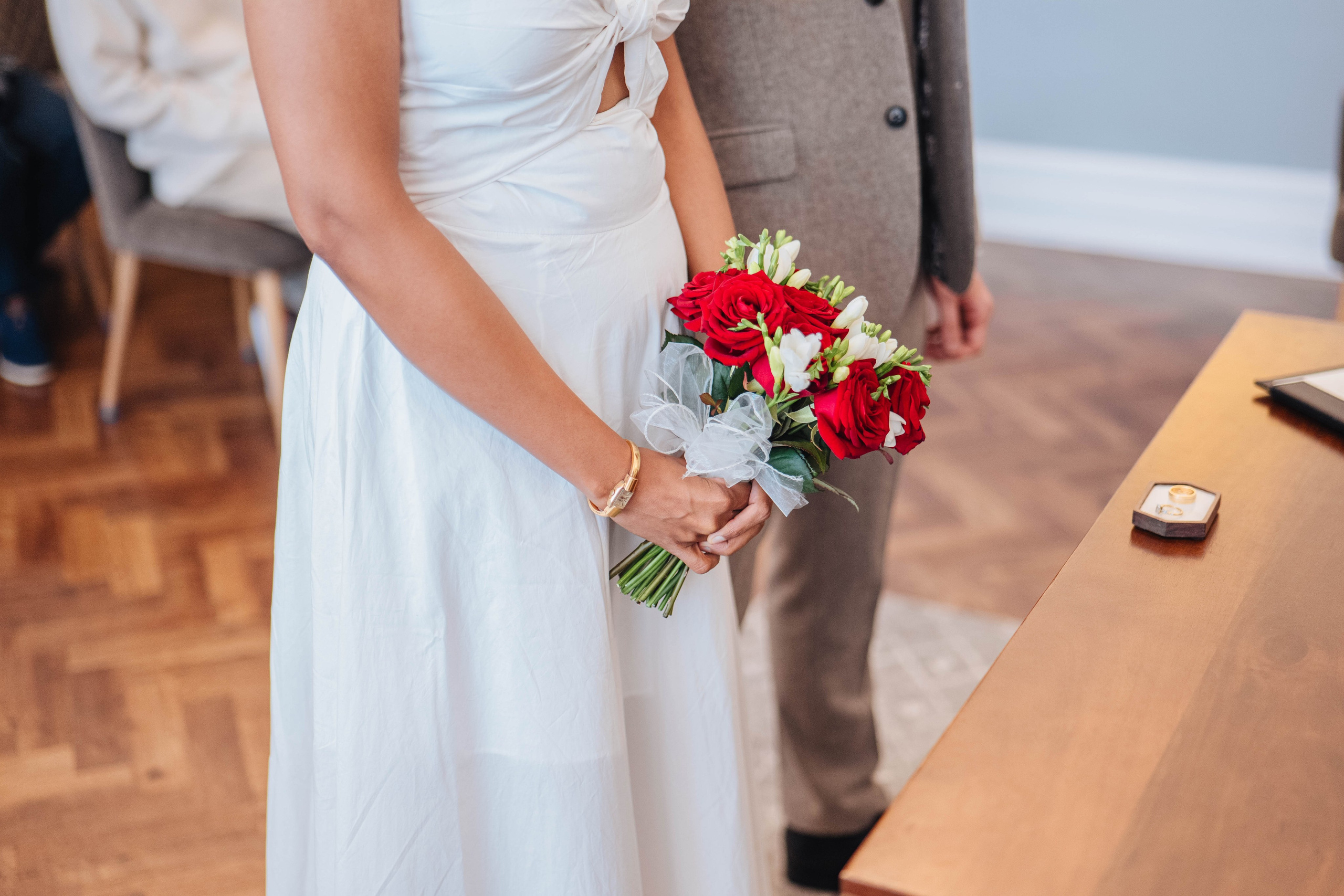 Wedding photography in london, bride close up, red flowers