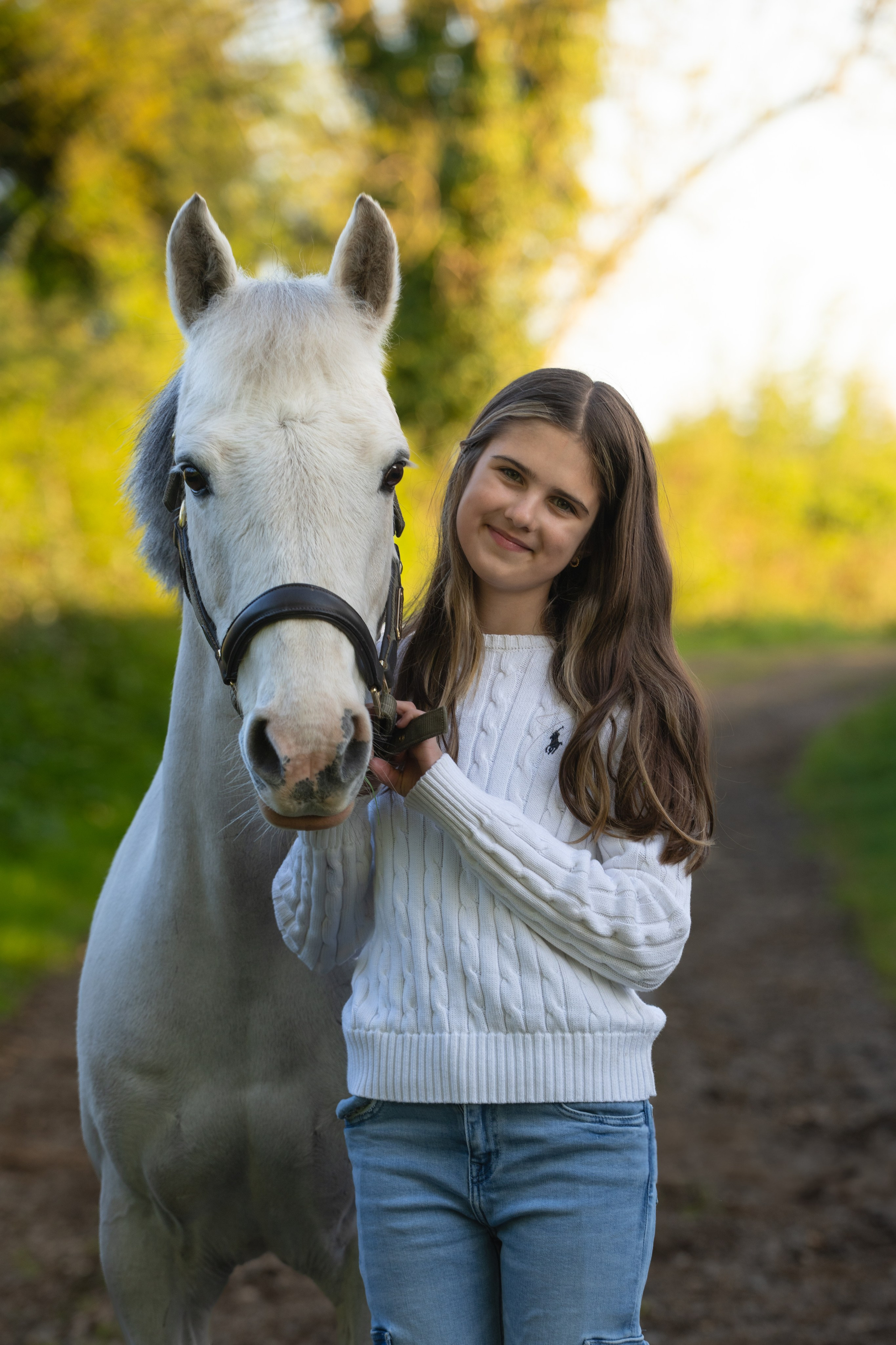 Rider and horse captured mid-stride on country path in evening light