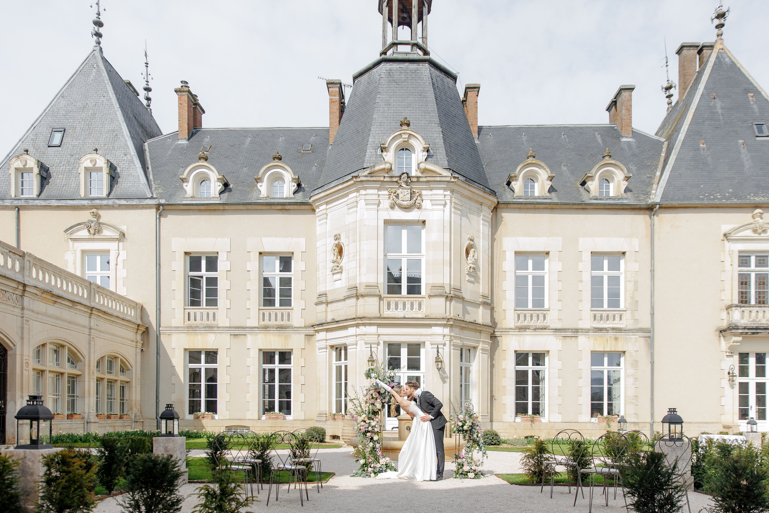 Charming chateau in France featuring vibrant flowers and a serene atmosphere for outdoor ceremonies.