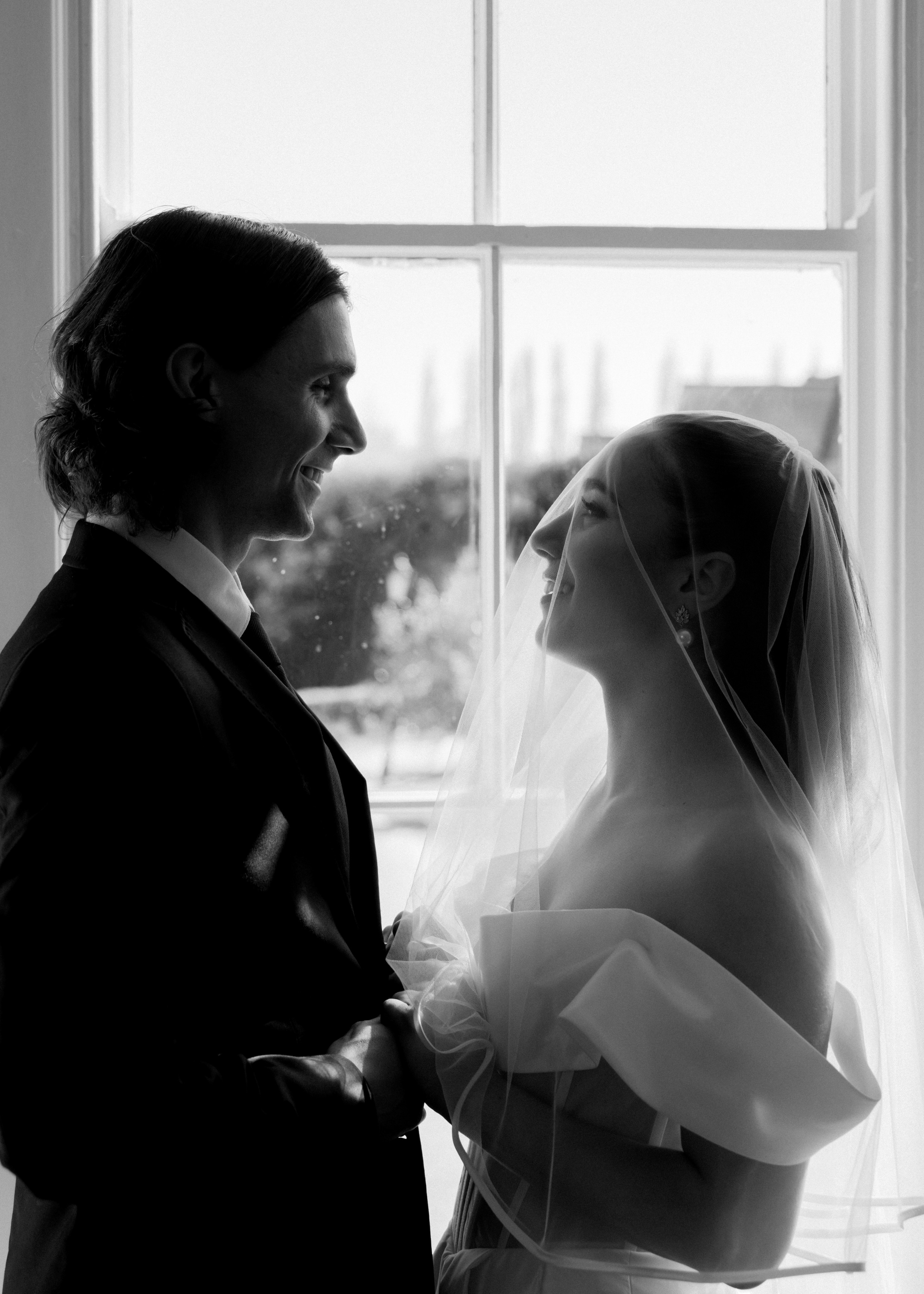 Elegant wedding portrait of bride and groom walking through the streets of ParisRomantic elopement moment captured in soft evening light in Paris, FranceLuxury wedding ceremony setup in a historic French venue with natural floralsCandid black and white photo of a couple at their city wedding in London, UKTimeless couple portrait in front of Marylebone Town Hall, LondonEditorial-style bridal preparation in a classic townhouse in the heart of LondonSoft light bridal portrait in a countryside château wedding in FranceFine art flat lay with French-inspired wedding details and vintage texturesCinematic golden hour photo at a UK estate wedding with historic architectureLuxury wedding tablescape with candles and florals at a London reception