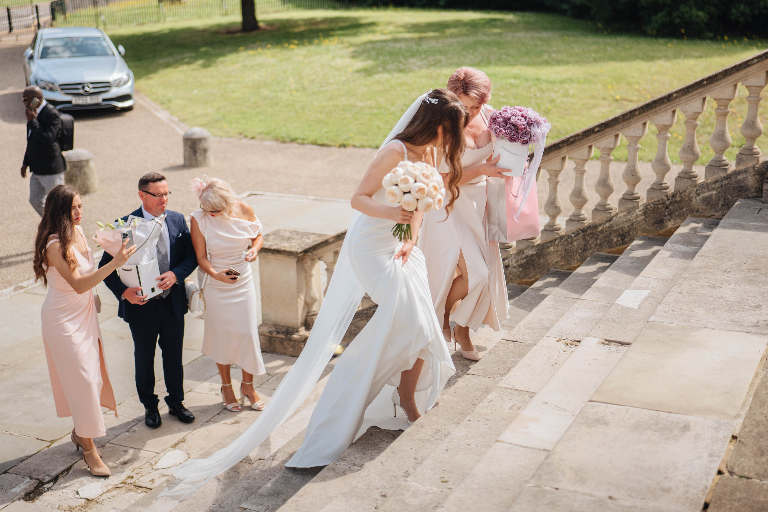 bride entering the venue with large beautiful stairs