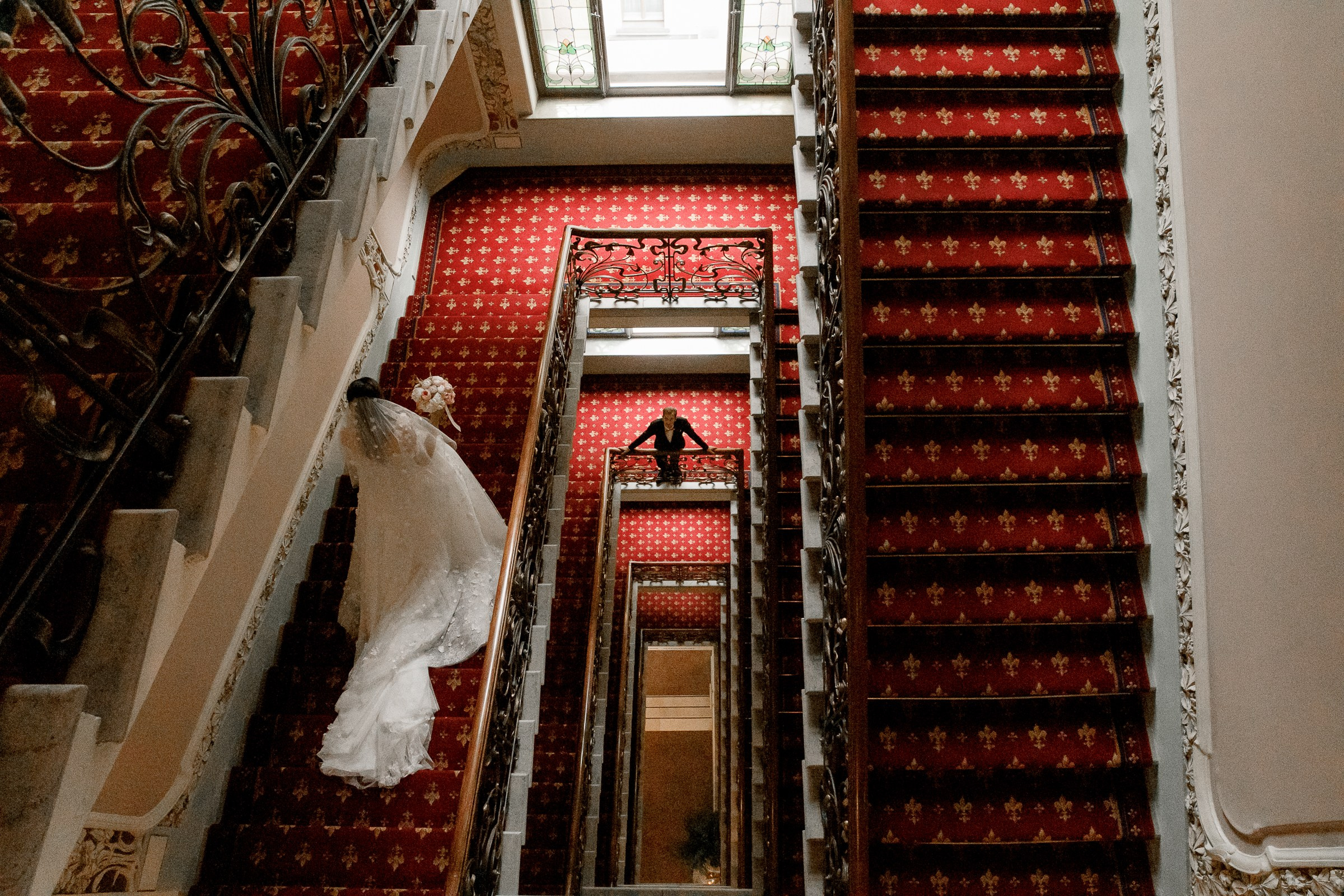 Bride’s staircase moment with groom below, by Bude reportage photographer.