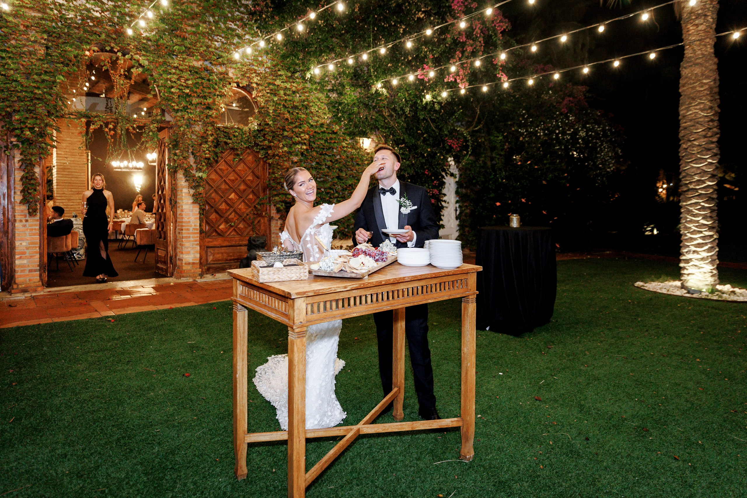 Bride and groom during the cake-cutting ceremony at a Barcelona wedding, sharing in the joy.