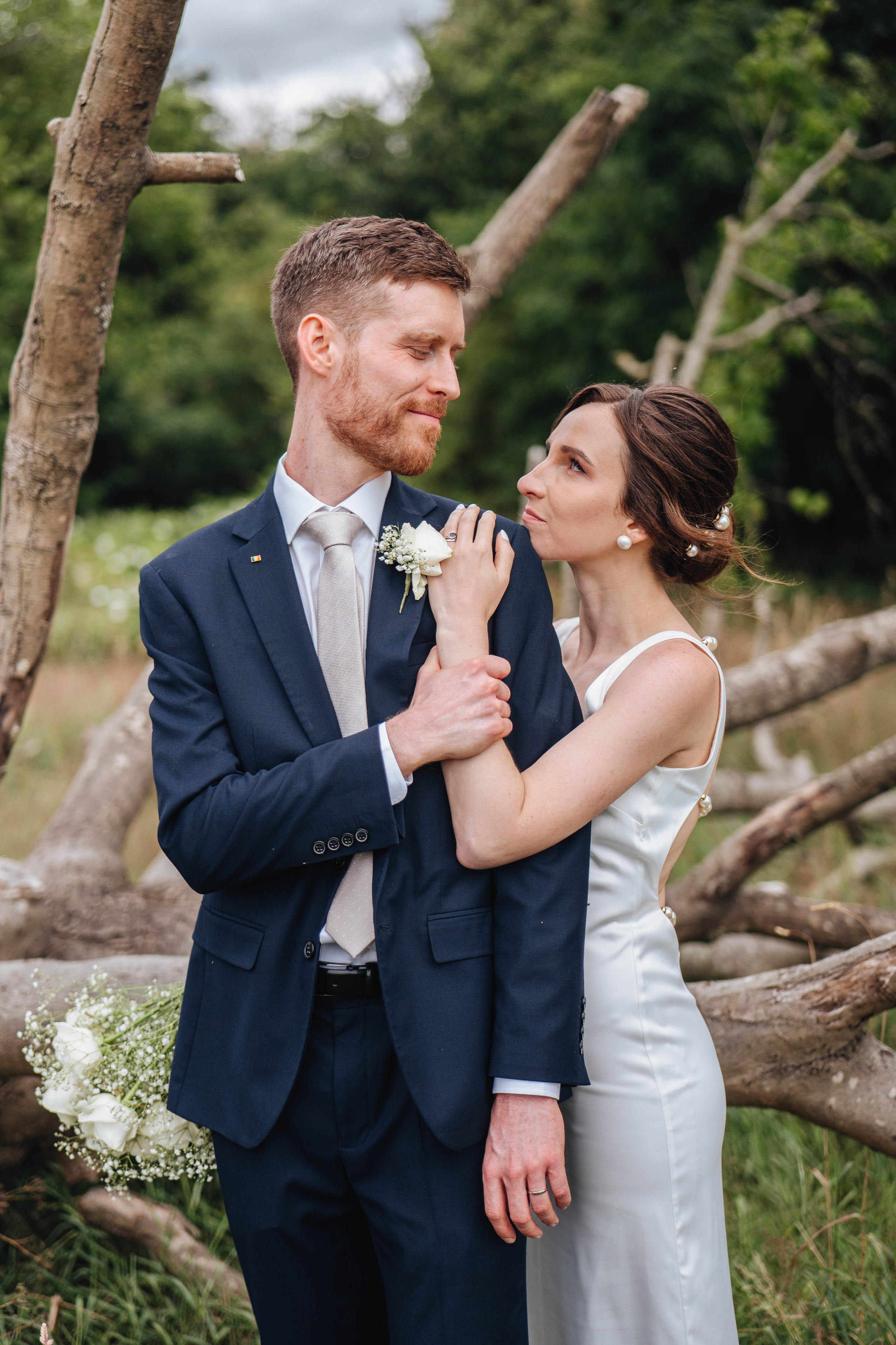 bride hugging the broom from the back and smiling