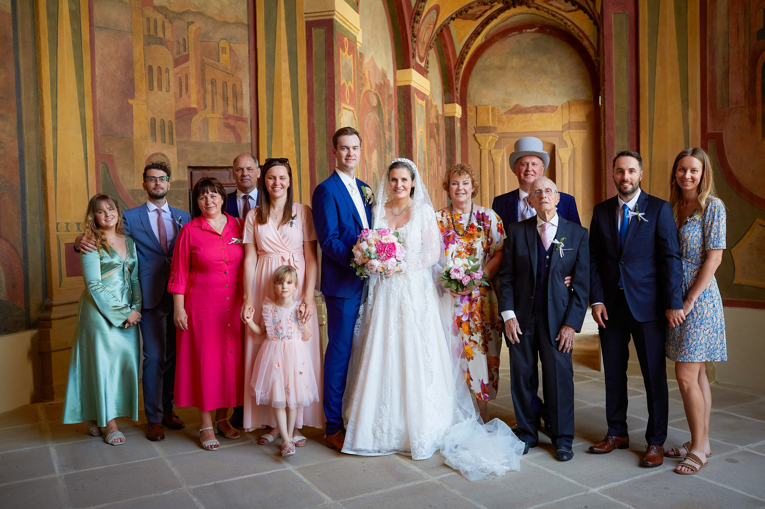 A portrait of the bride & groom and their close family members  is captured against the bacdrop of the Ledebour Garden's historic paintings.