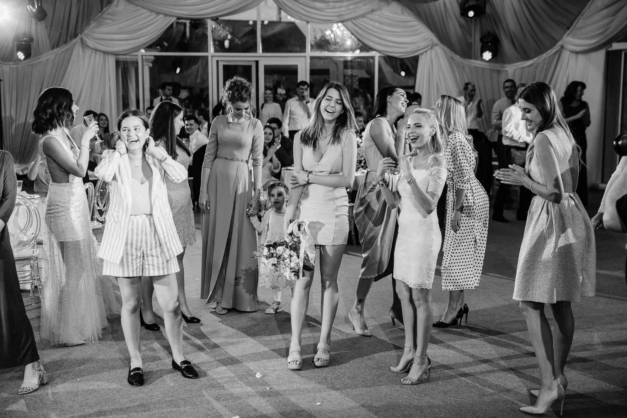 Bouquet toss winner, by Tanya Bodgan, Devon wedding photographer.