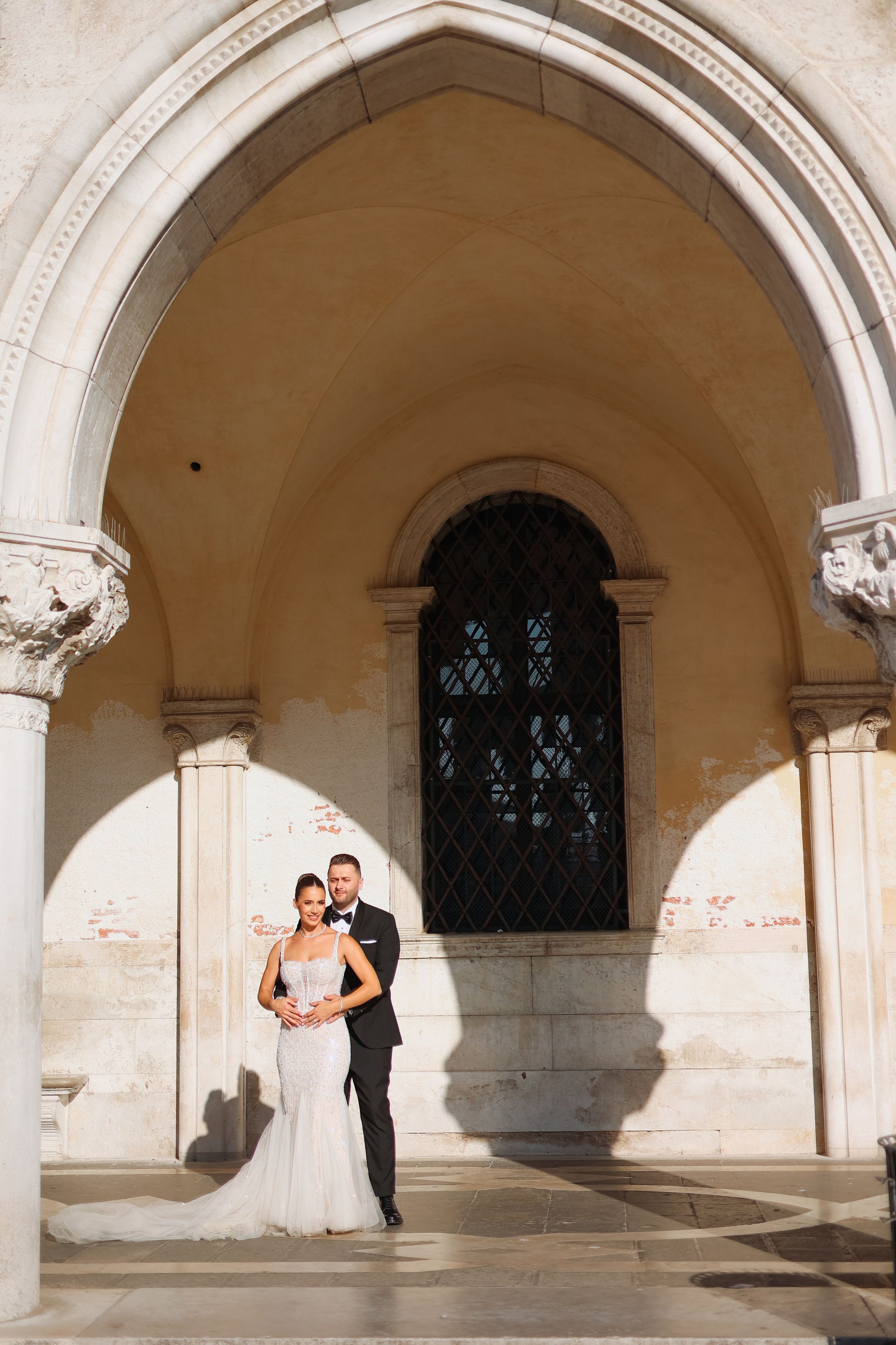 Bride and groom standing on a picturesque Venice location