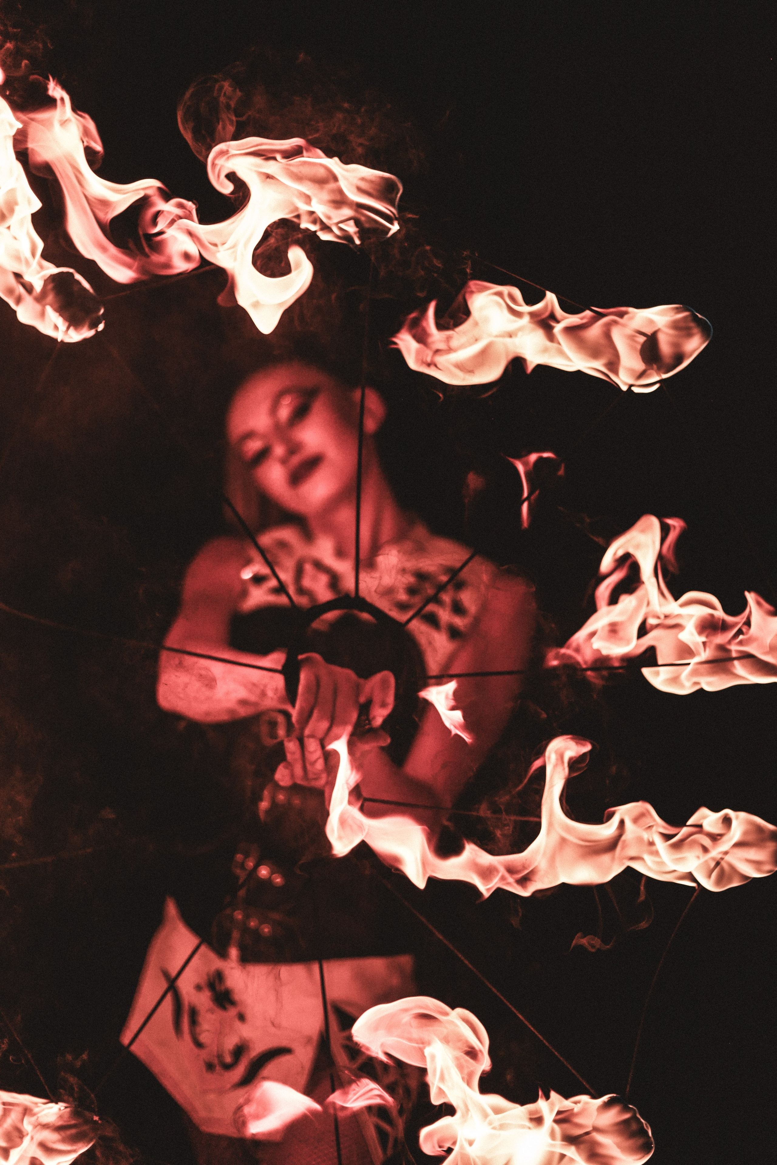 Fire artist holds fire, dramatic portrait of a performer