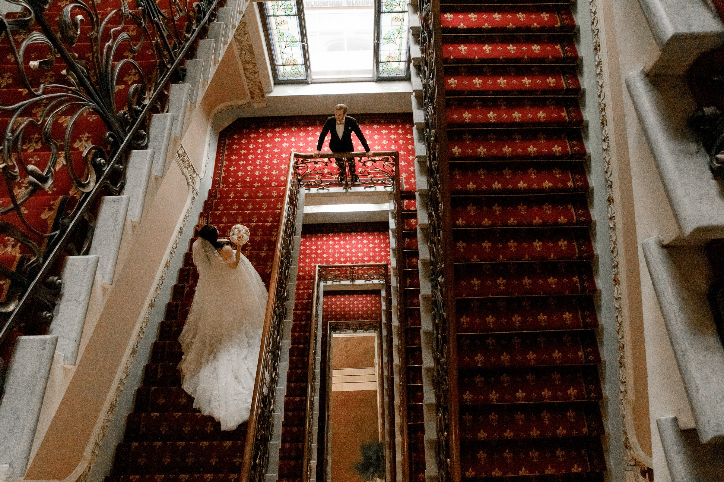 Bride and groom on staircase , by Cornwall reportage photographer.