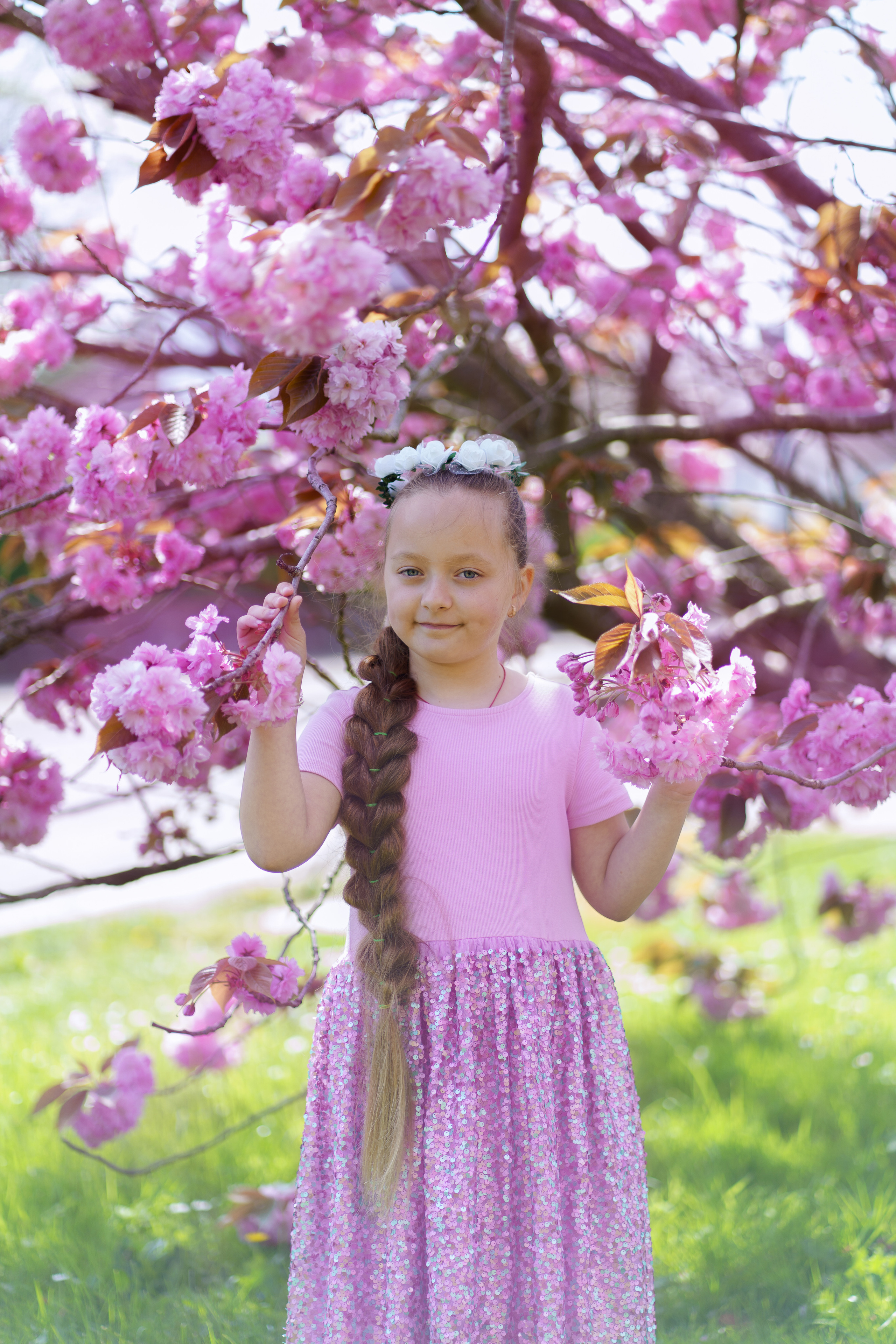 Little sisters in pink blossom. Jelena Upleja children and family photographer in Bognor Regis
