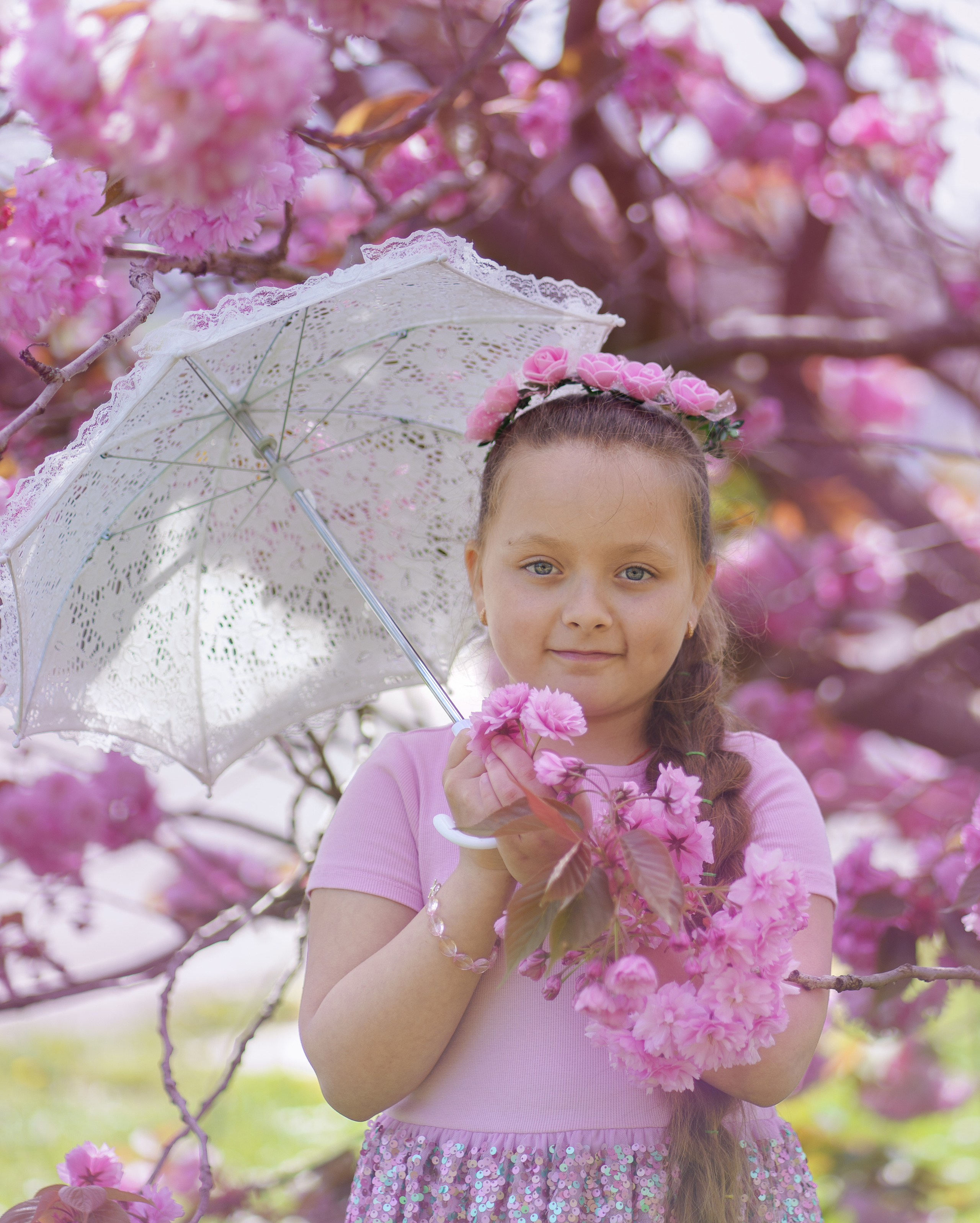 Little sisters in pink blossom. Jelena Upleja children and family photographer in Bognor Regis