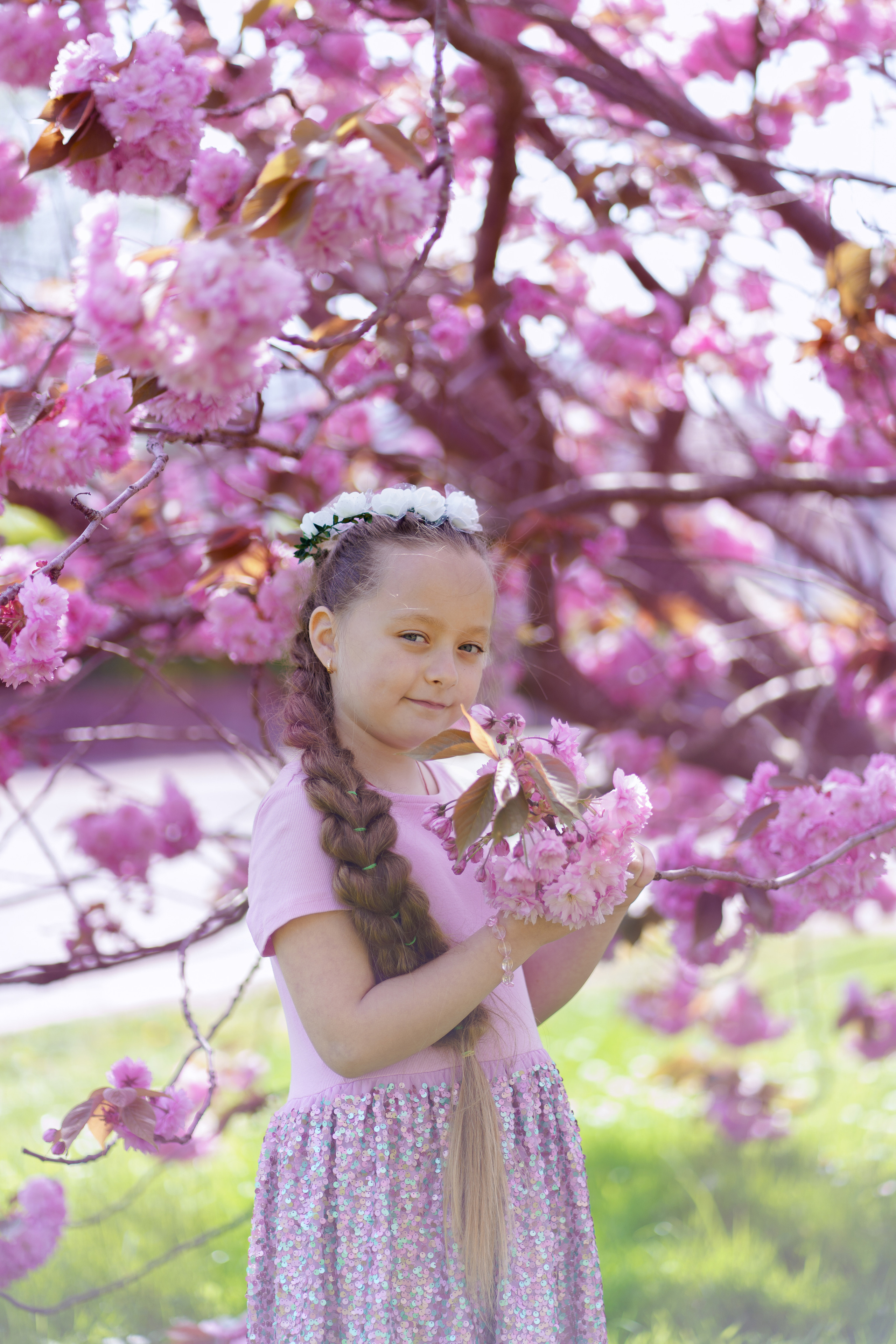 Little sisters in pink blossom. Jelena Upleja children and family photographer in Bognor Regis