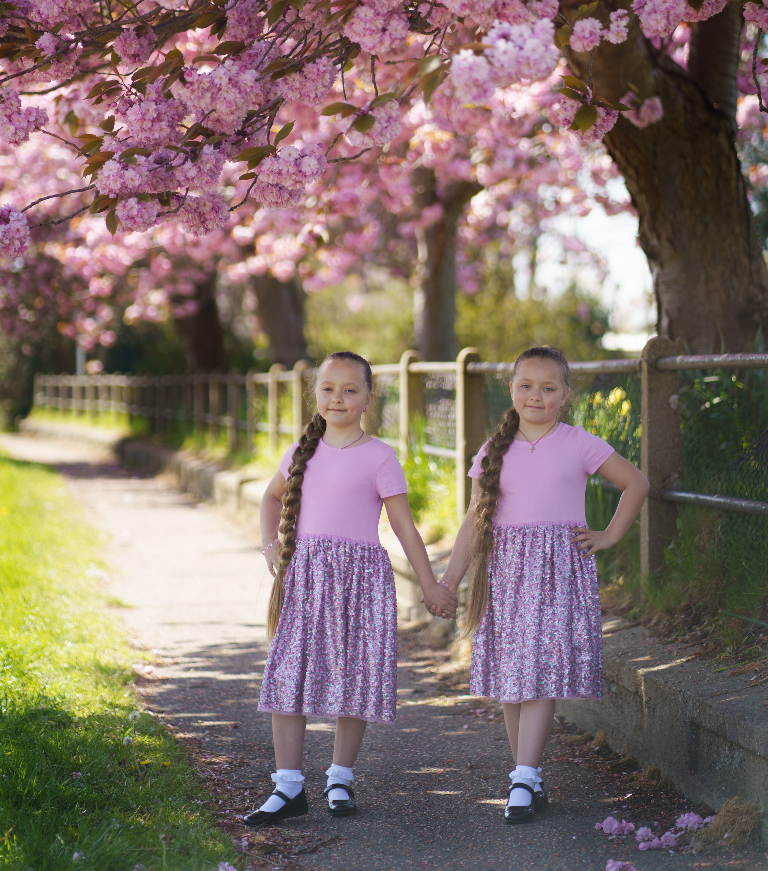 Little sisters in pink blossom. Jelena Upleja children and family photographer in Bognor Regis
