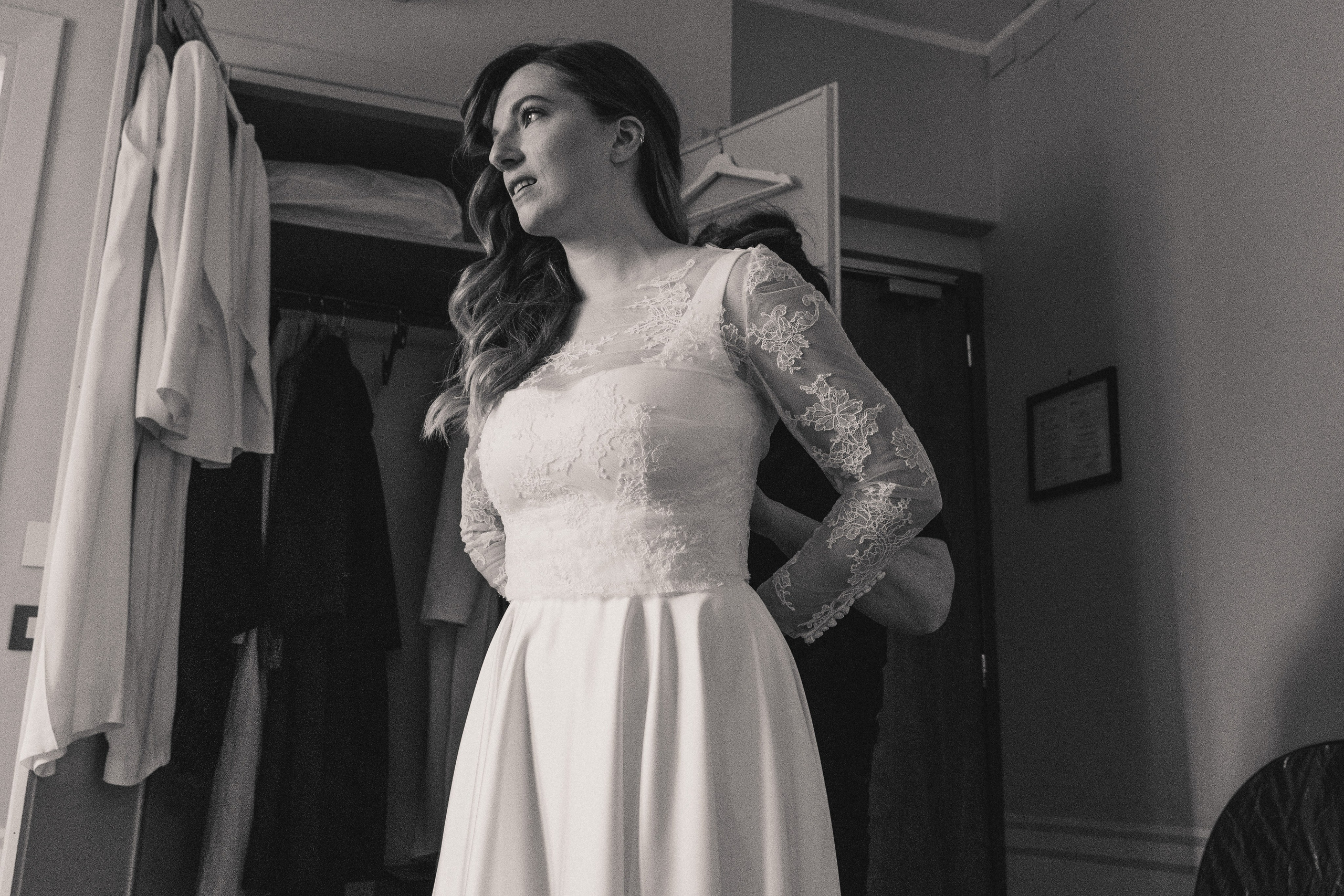 A bride getting ready at Hotel Lancelot, adjusting her wedding dress.