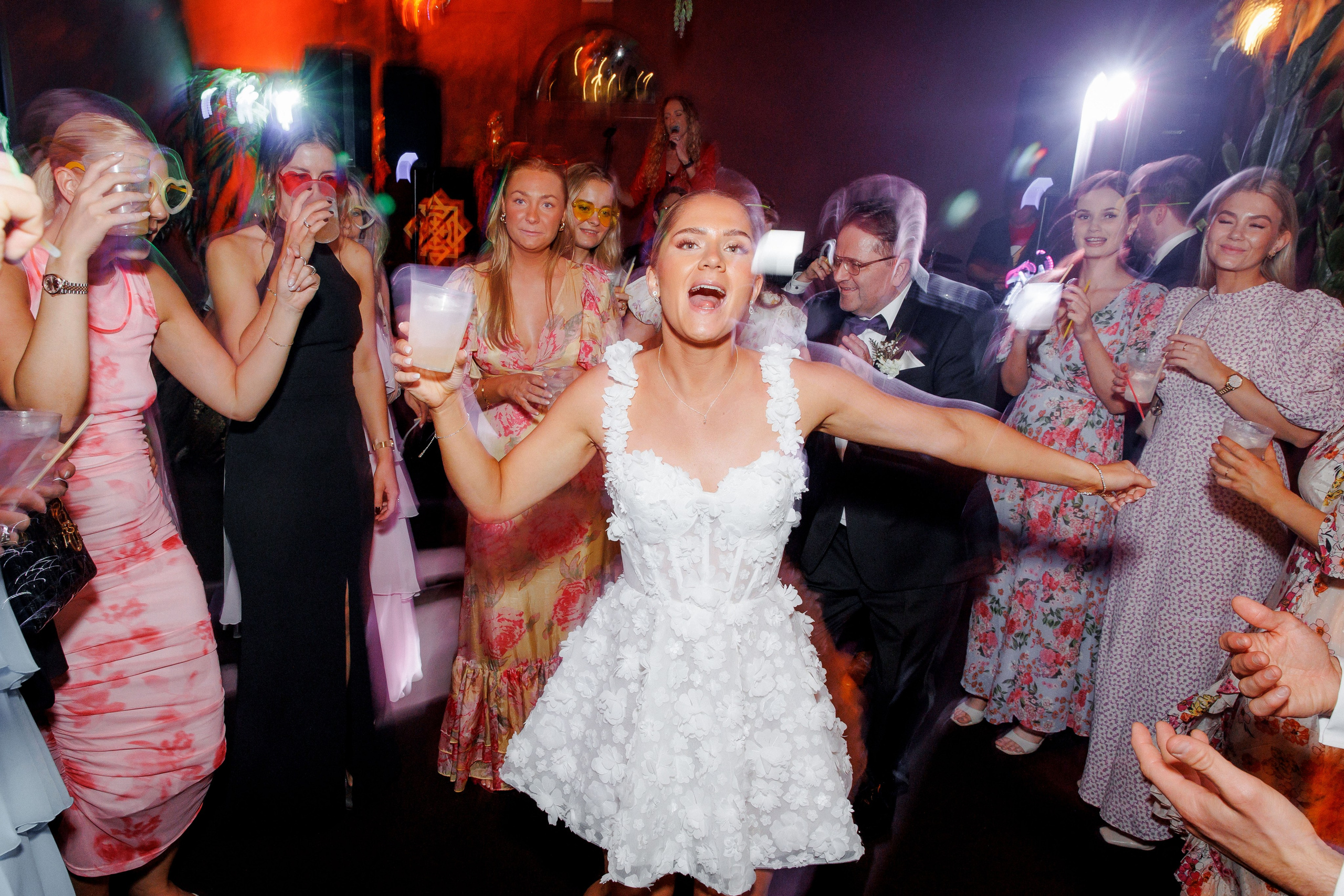 Energetic wedding guests dancing on the dance floor during the reception in Barcelona, highlighting the celebration.