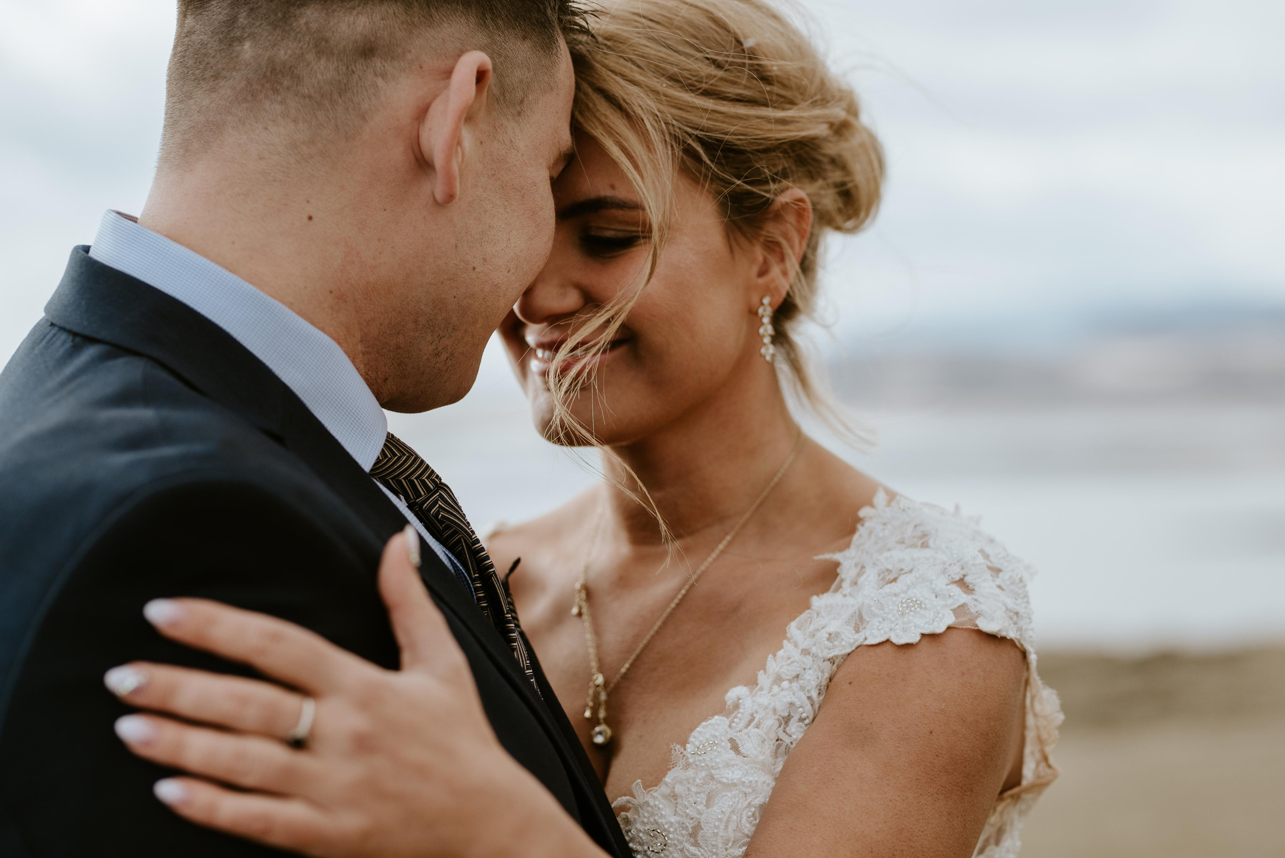 Silhouette of newlyweds against a glowing Icelandic sunset at Reynisfjara Beach